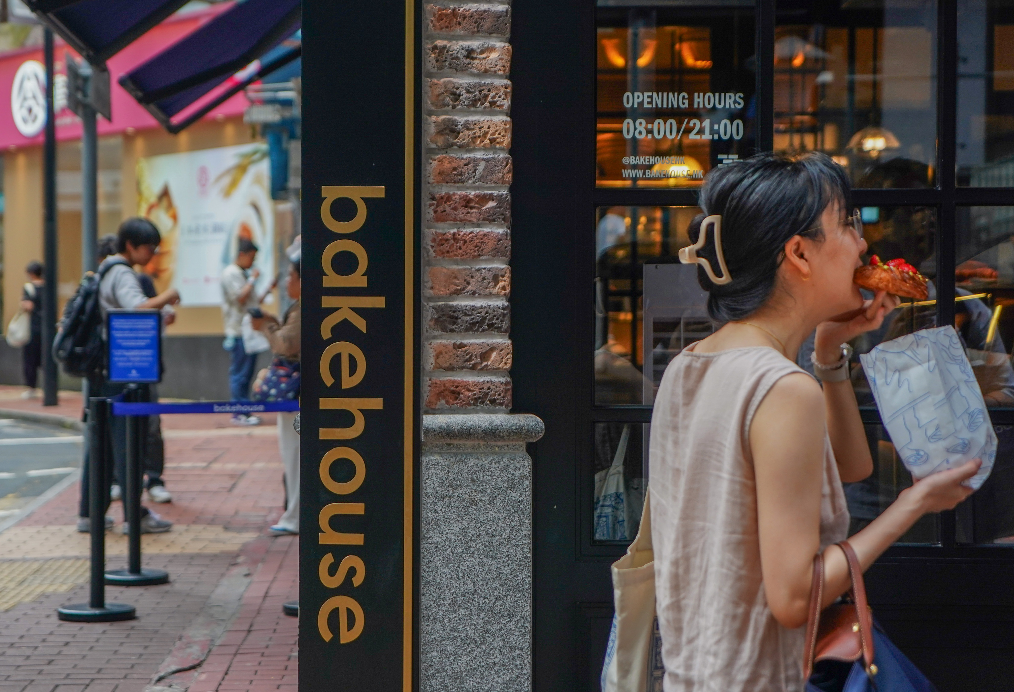 Customer enjoying a pastry outside a Bakehouse store, Causeway Bay. Photo: Alexander Mak.