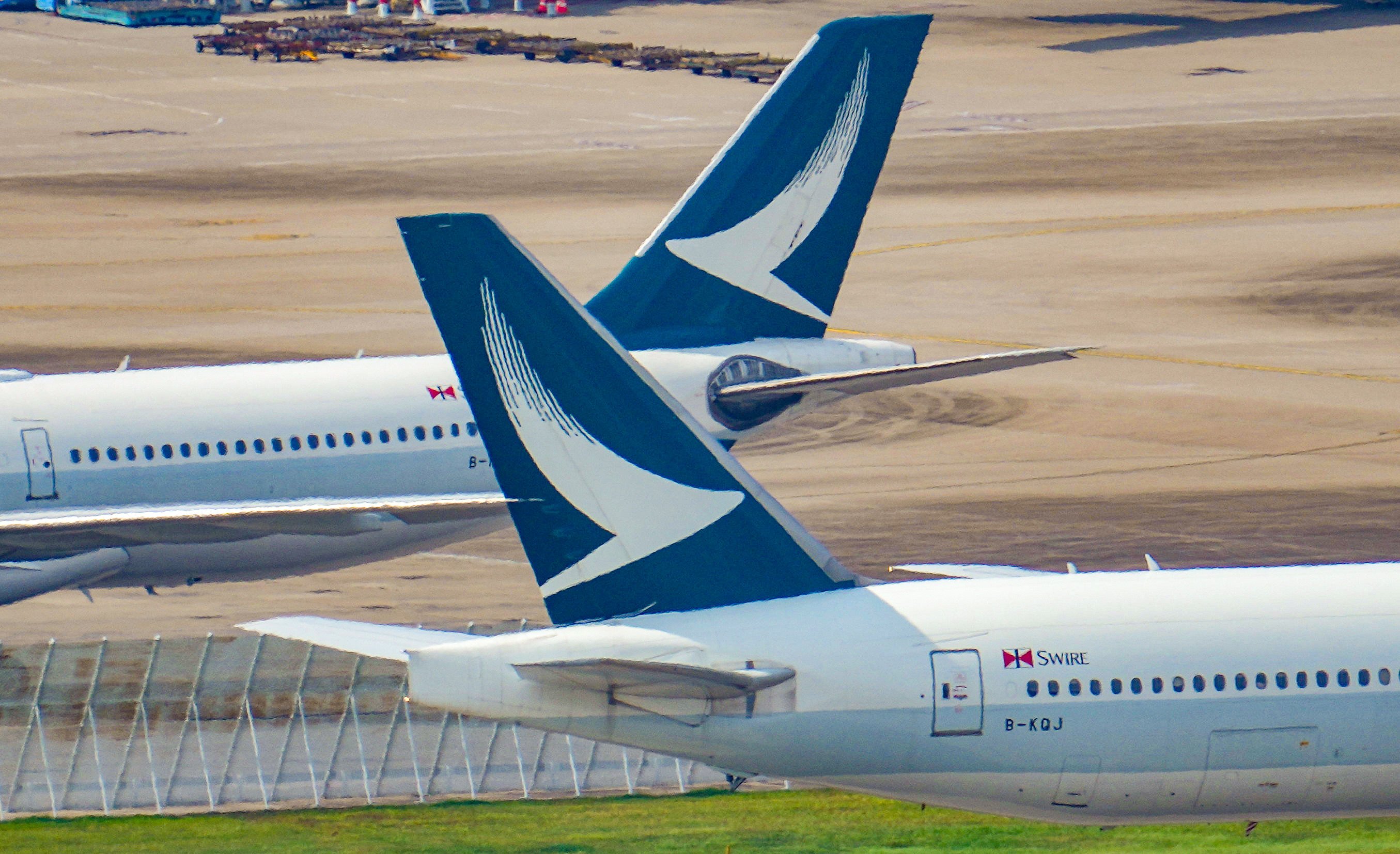 Cathay Pacific planes at Hong Kong International Airport. The airline has banned two passengers who abused a fellow traveller from mainland China on a London-bound flight. May Tse