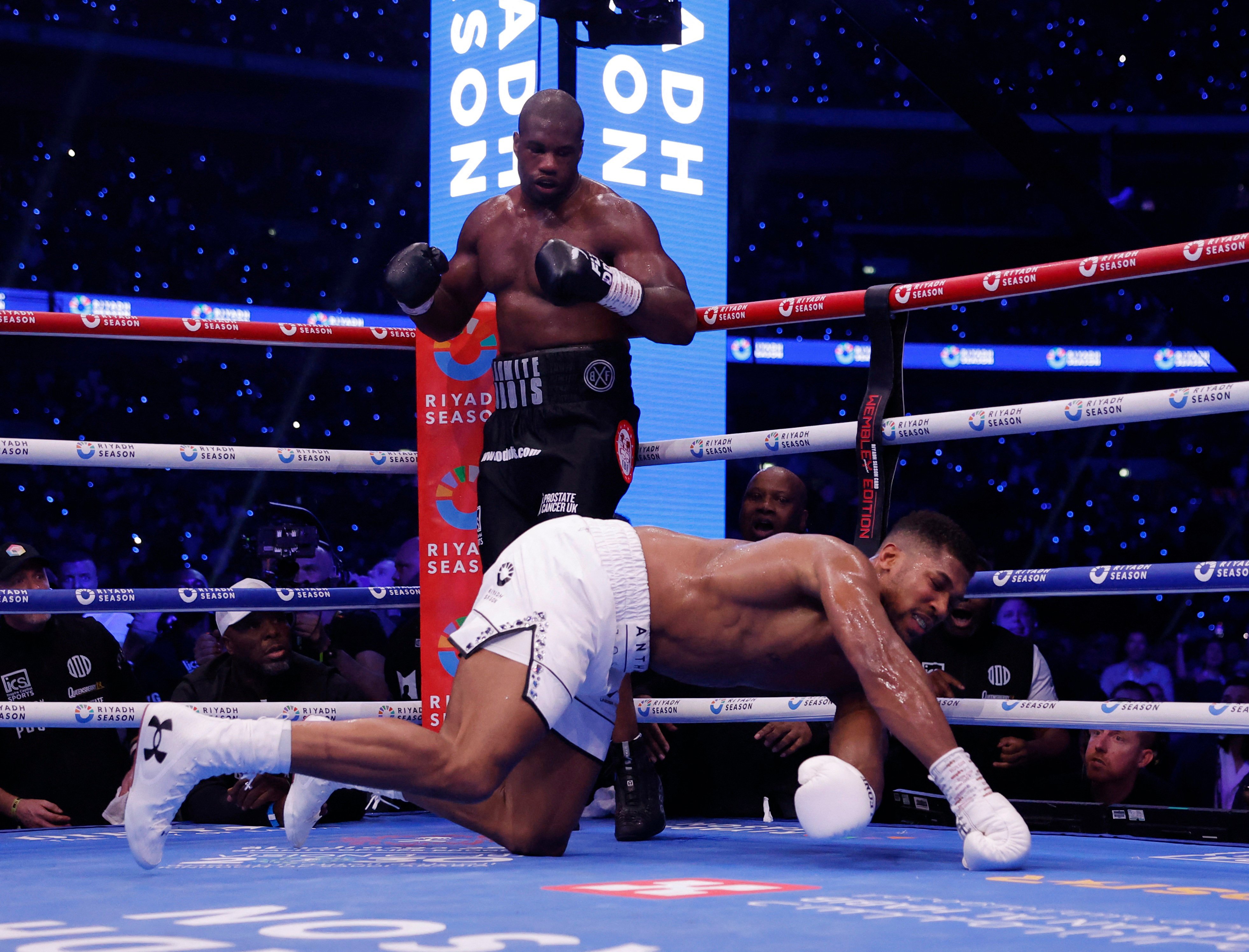 Anthony Joshua gets knocked down by Daniel Dubois at Wembley Stadium. Photo: Reuters