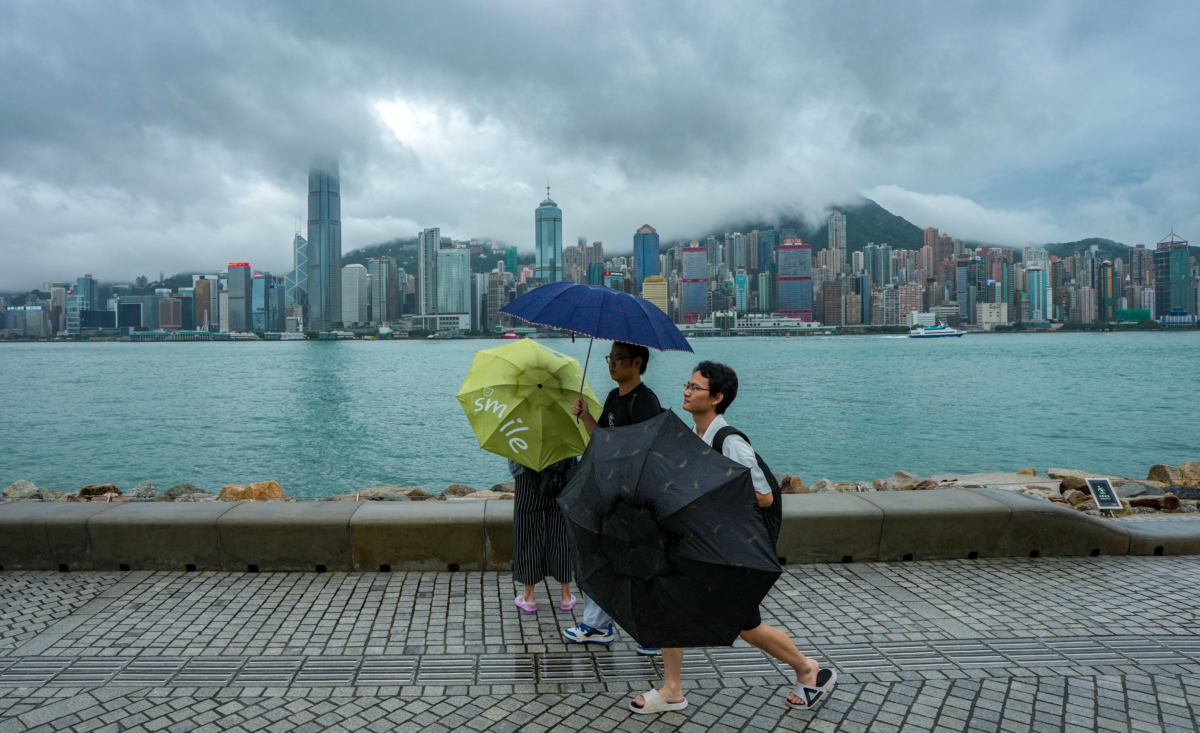 Visitors along the waterfront at West Kowloon Art Park on a rainy day. Photo: Eugene Lee