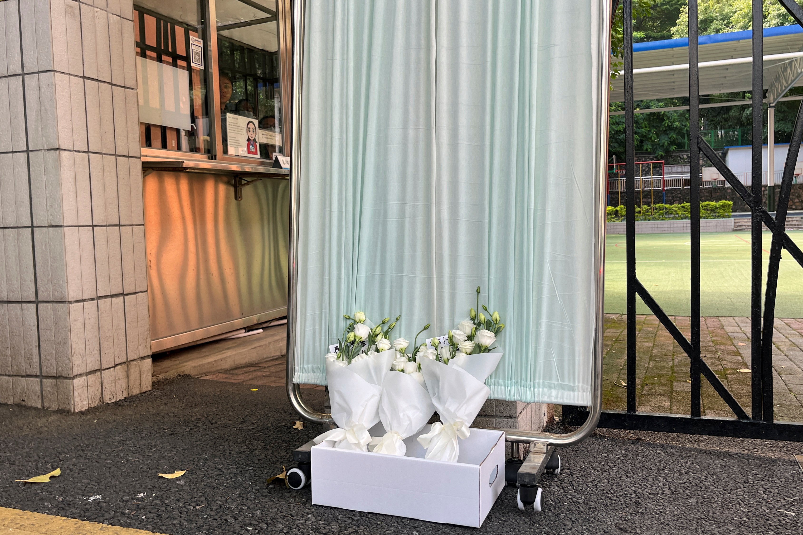 Bouquets of flowers lay outside Shenzhen Japanese School following the death of the 10-year-old child who was stabbed. Photo: Reuters