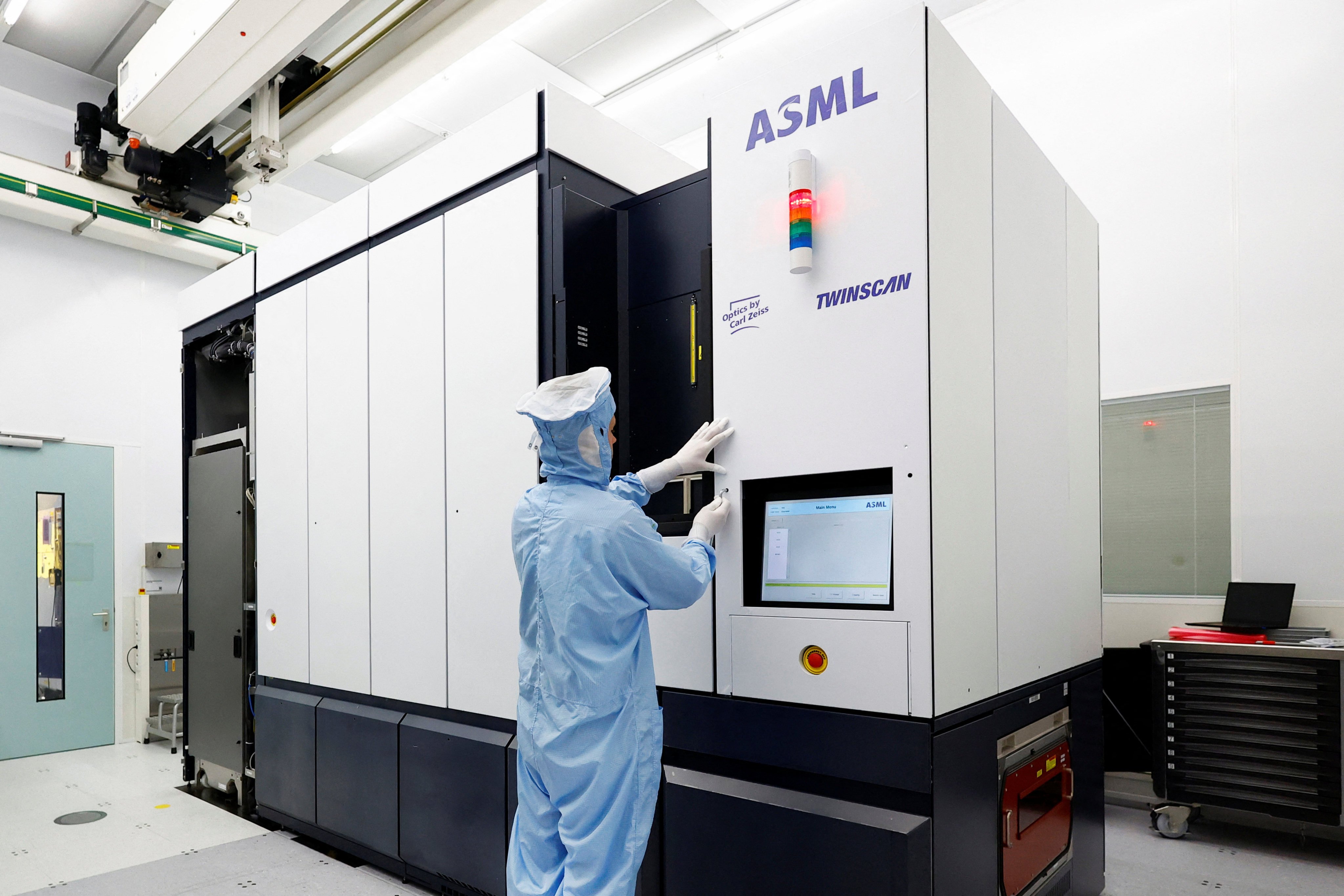 An assembly engineer works on a TWINSCAN DUV lithography system at ASML in Veldhoven, Netherlands on June 16, 2023. Photo: Reuters