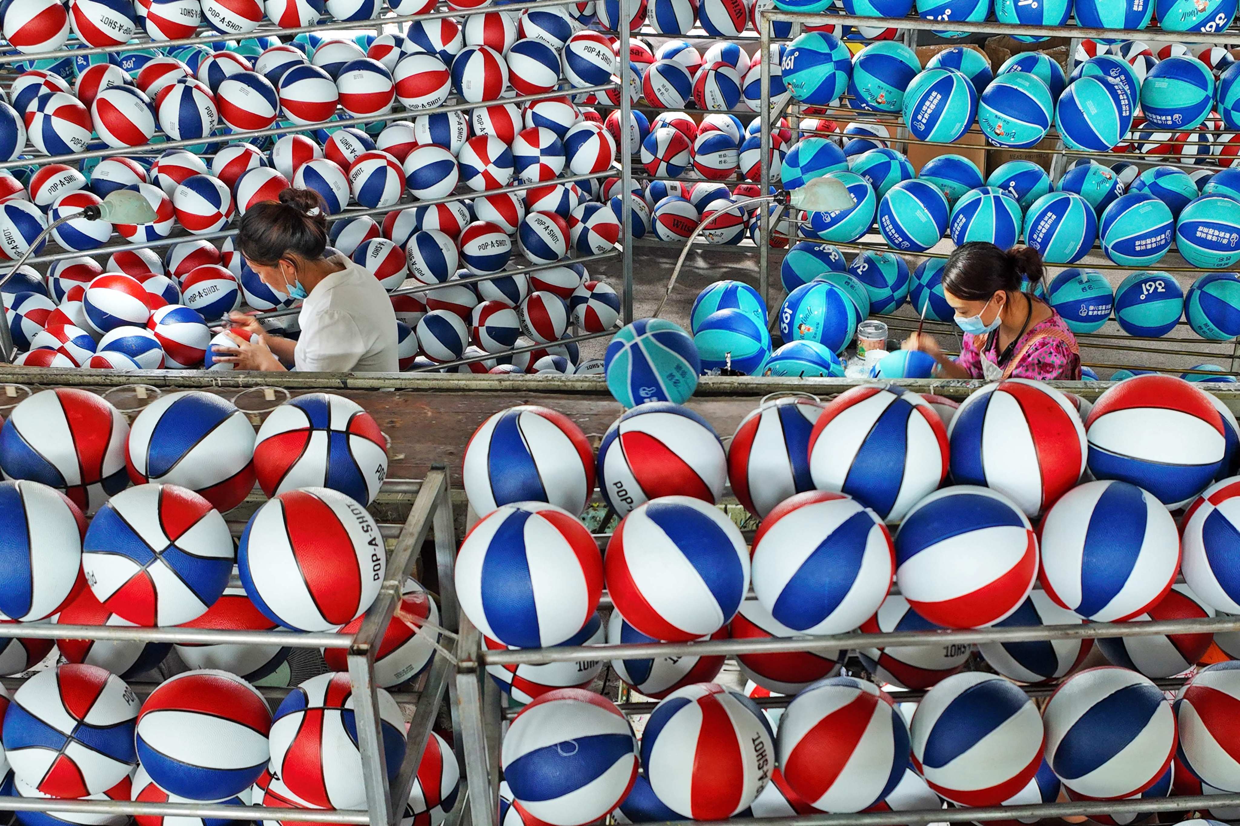 Employees producing basketballs at a factory in Sihong, in eastern China’s Jiangsu province. Photo: AFP