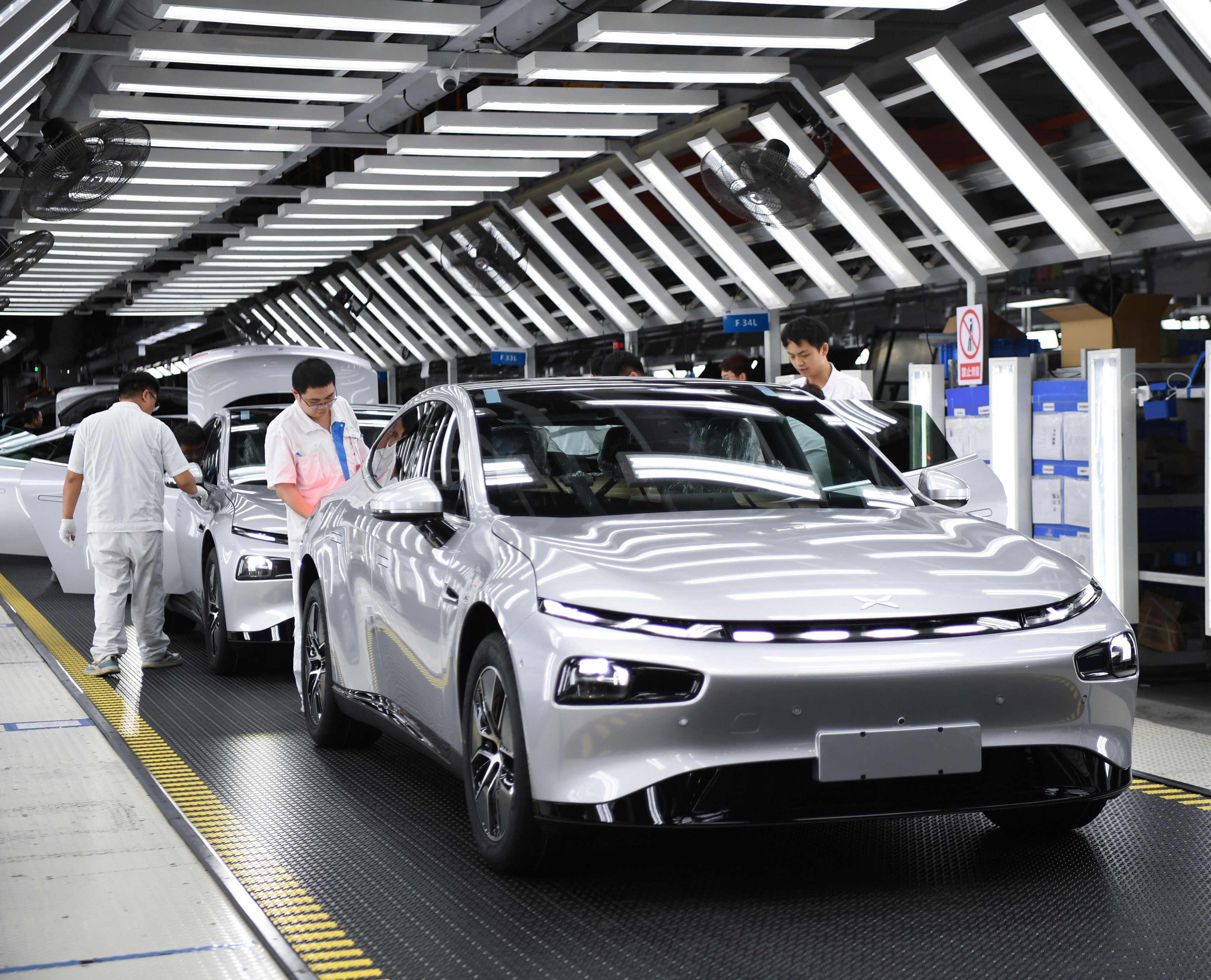 Workers check an Xpeng can at a plant in Zhaoqing, in southeast China’s Guangdong province, on October 09, 2023. Photo: Xinhua