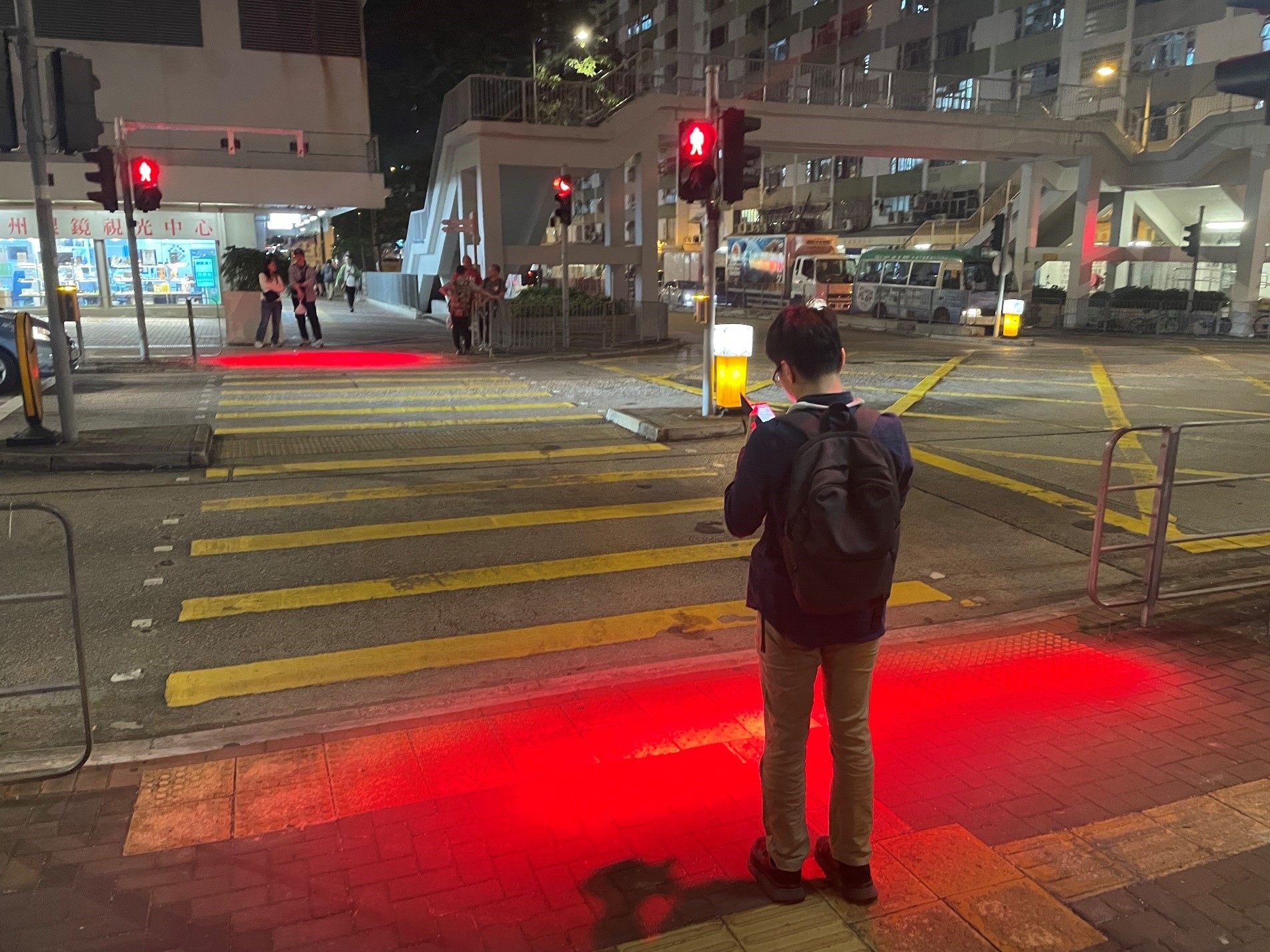 Red lights shine on the ground  in Hong Kong to warn smartphone-using pedestrians about traffic signals. Smartphone addiction causes multiple problems, and we should all reduce our use of the gadgets, a psychologist says. Photo: Hong Kong Transport Department