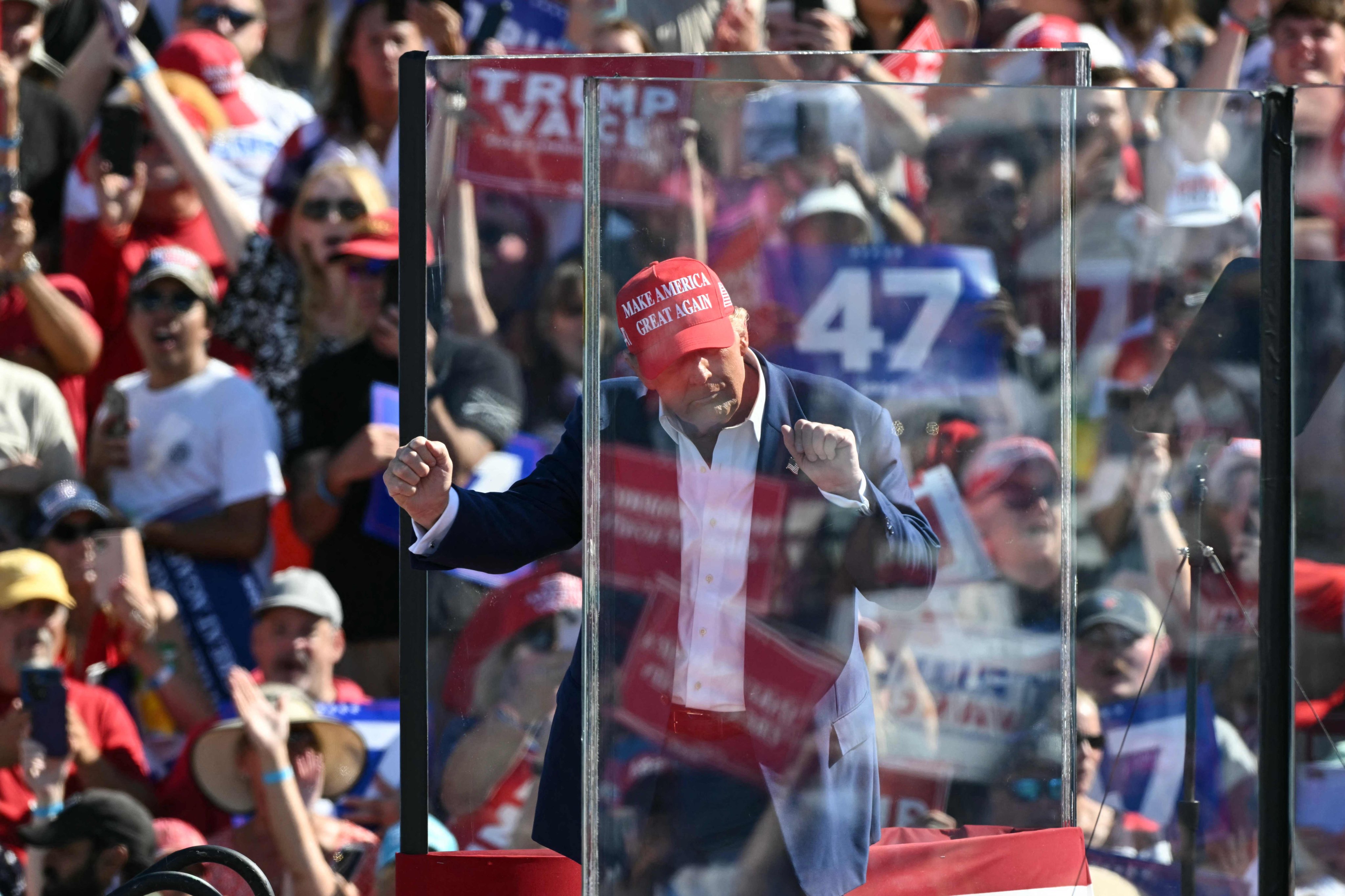 Donald Trump dances behind bulletproof glass at a campaign rally in Wilmington, North Carolina. Photo: AFP