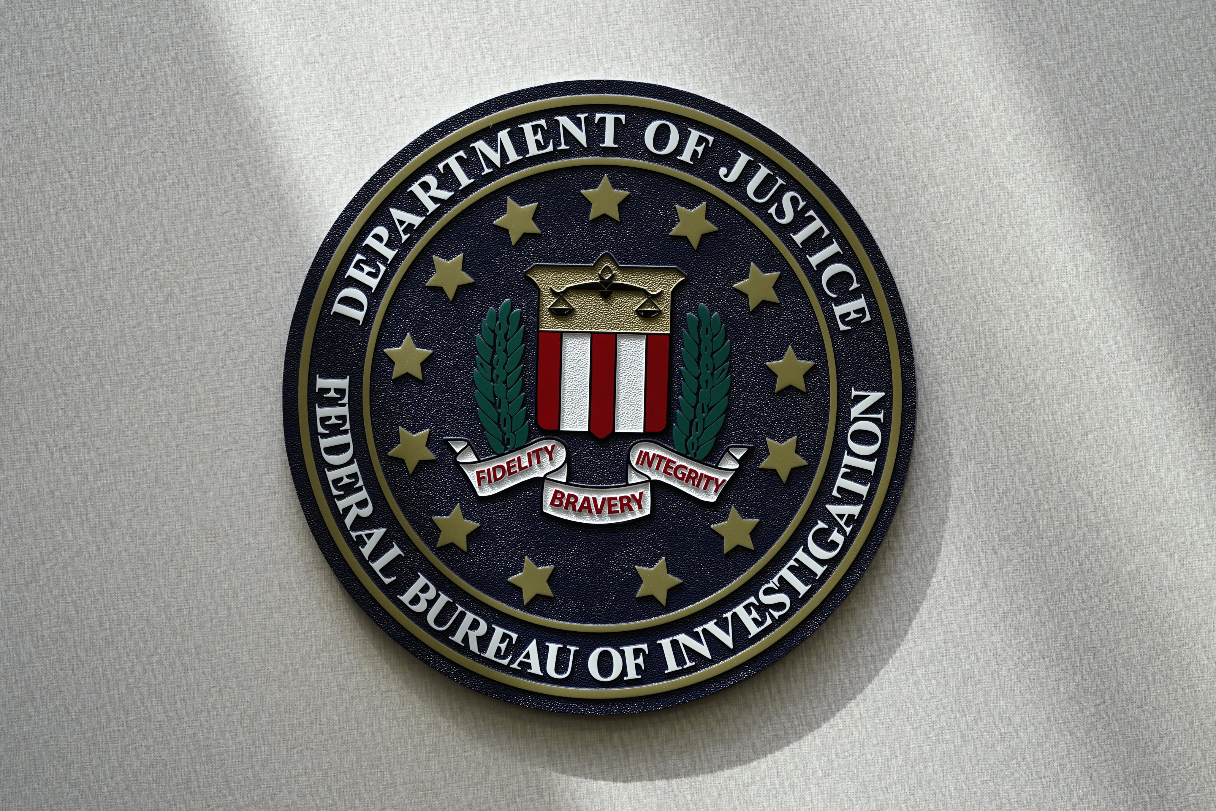 An FBI seal is seen on a wall Omaha, Nebraska, in August 2022. Oran Alexander Routh was arrested after authorities searched his home “in connection with an investigation unrelated to child exploitation”. Photo: AP