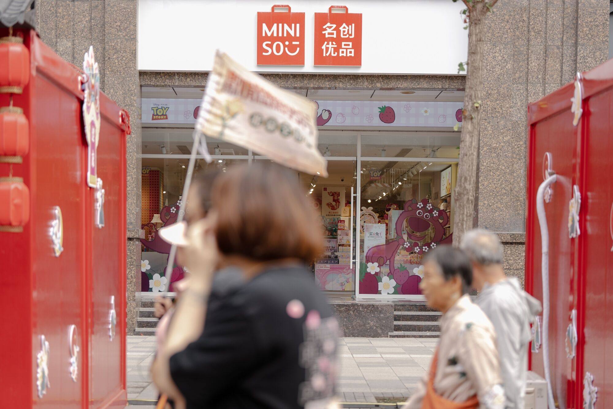 Pedestrians outside a Miniso Group store in the Wangfujing shopping area in Beijing. Photo: Bloomberg