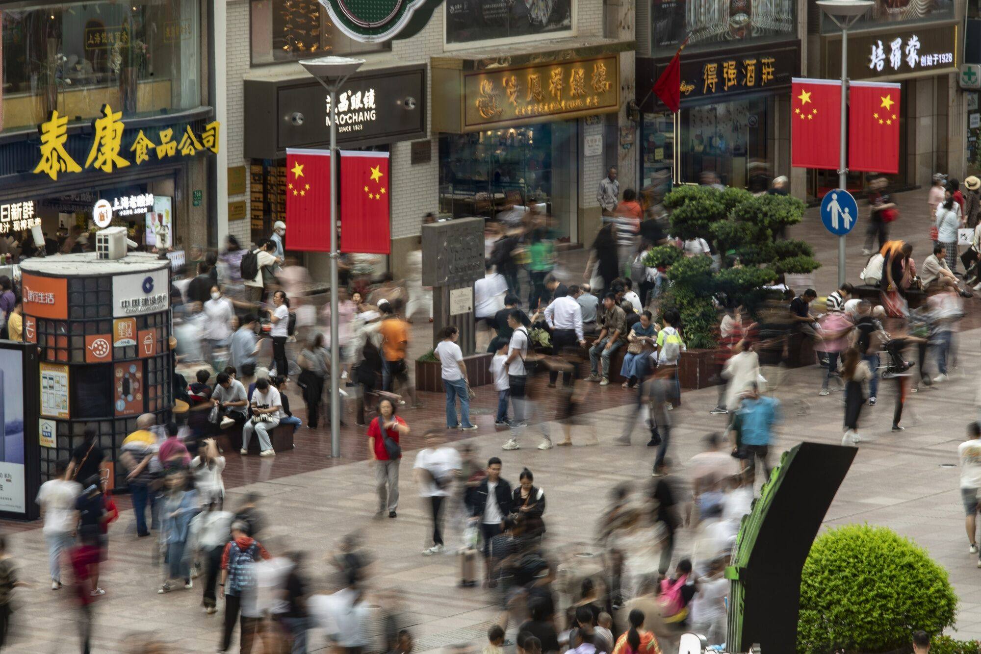 Crowds are seen in the Nanjing Road shopping district of Shanghai. Consumption vouchers will be made available in the city in the coming days to spur consumption. Photo: Bloomberg