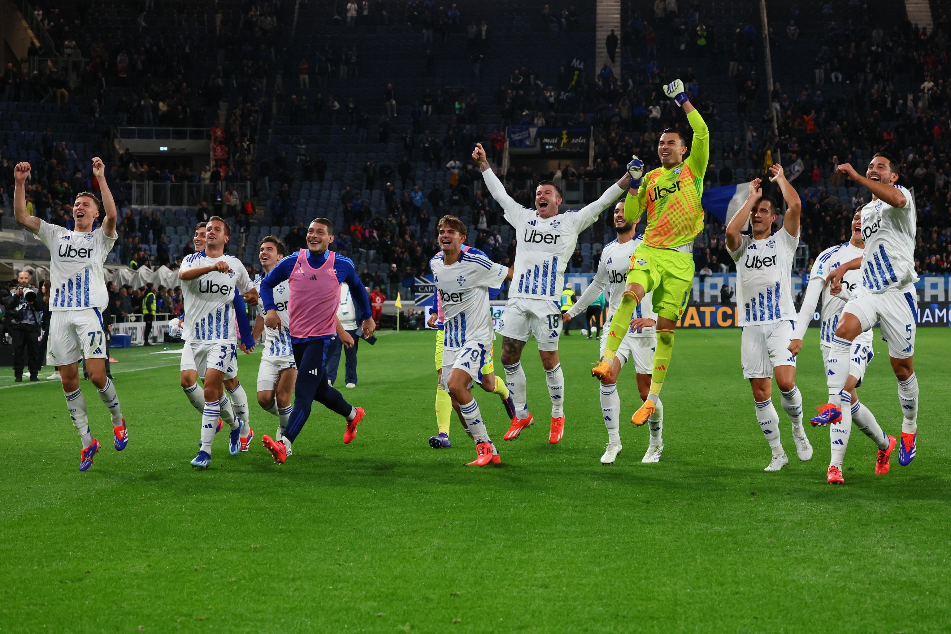 Como’s players celebrate with their supporters after winning their first Serie A match in 20 years. Photo: EPA-EFE