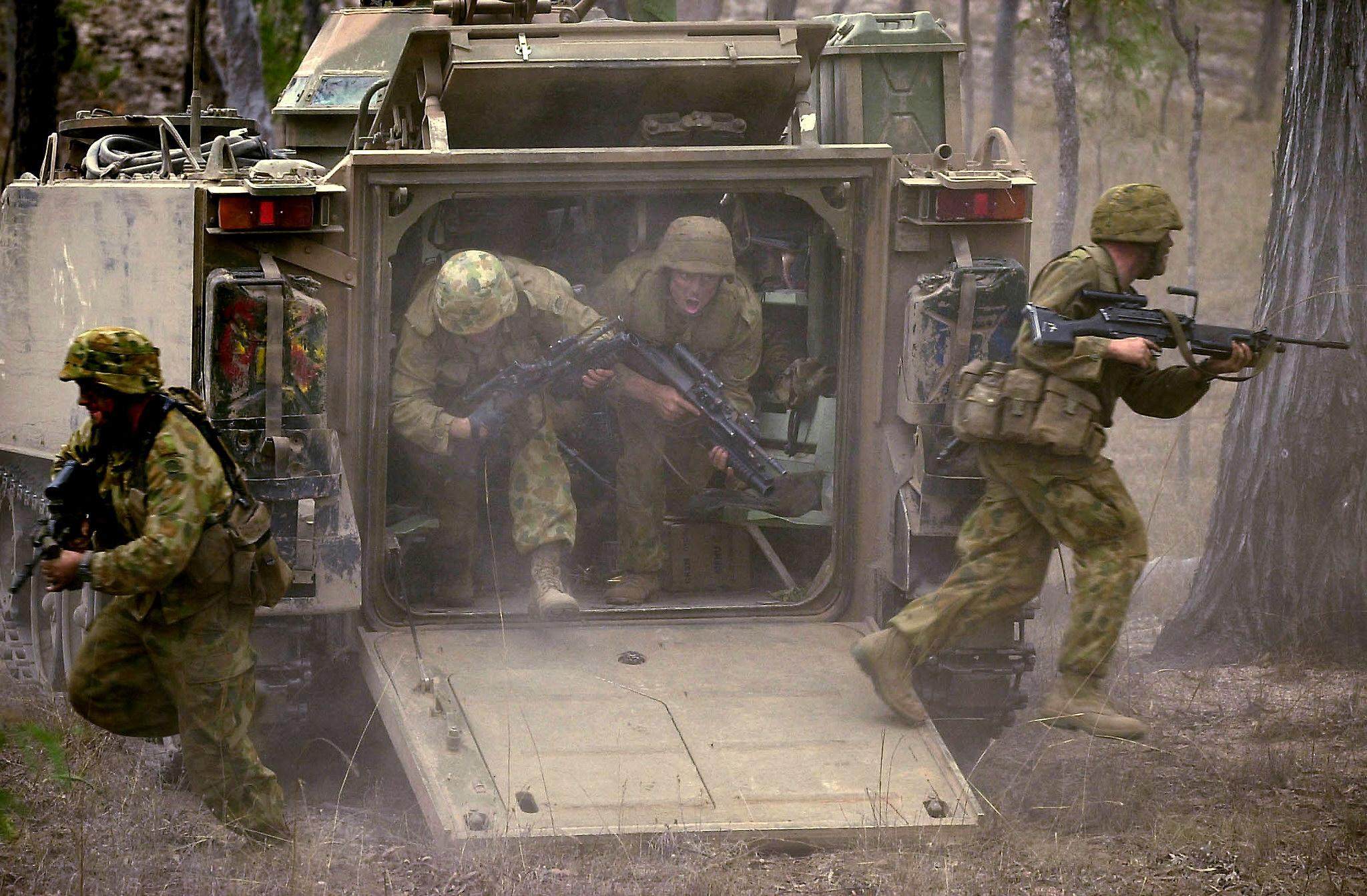 Soldiers exit an armoured personnel carrier during a live-fire assault exercise at Australia’s Shoalwater Bay Military Training Area. Photo: Australia Defence Department / AFP