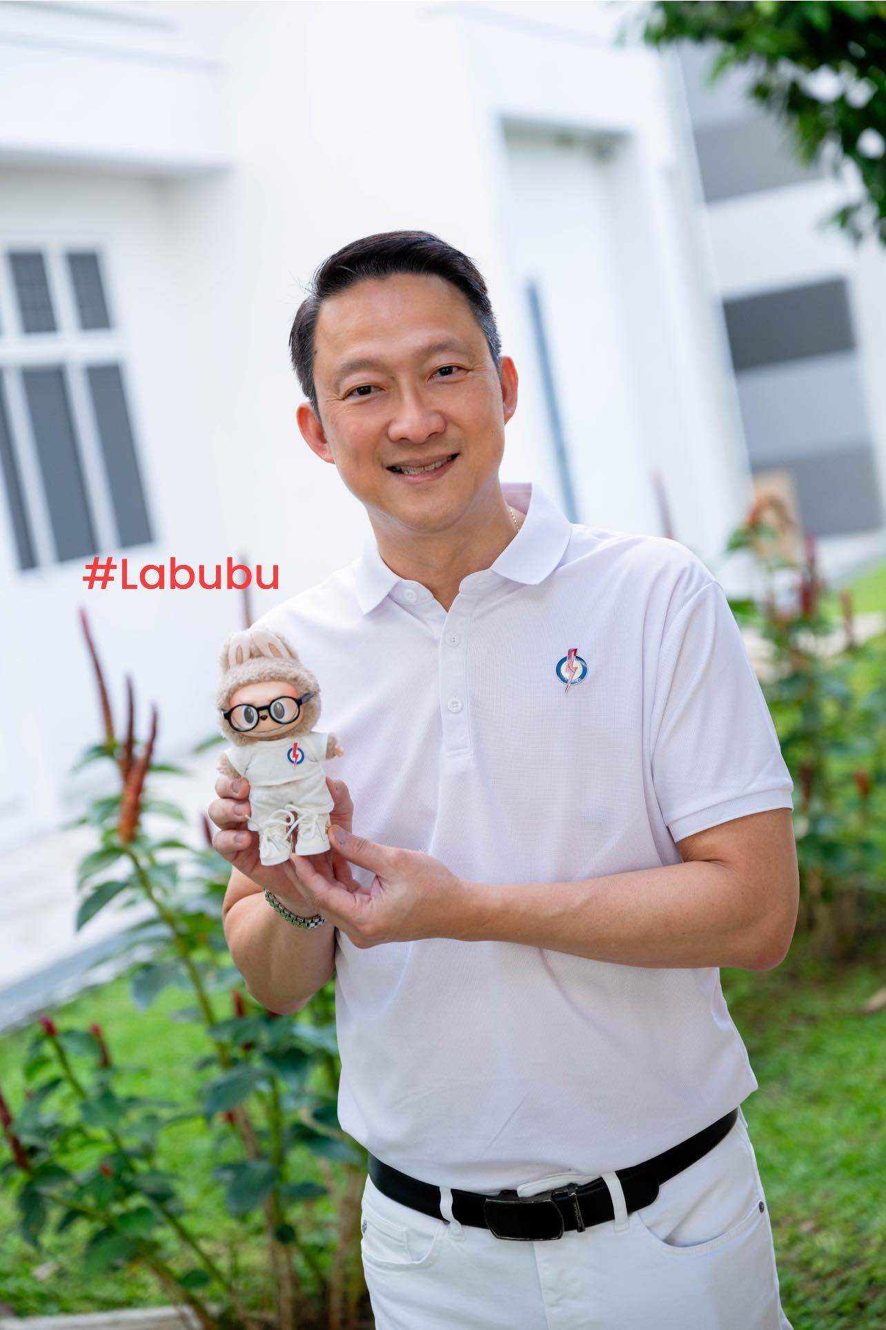 Singapore’s People’s Action Party politician Lam Pin Min with the Labubu doll dressed in PAP colours during a grocery distribution event in Sengkang on Sunday. Photo: Facebook/LamPinMin