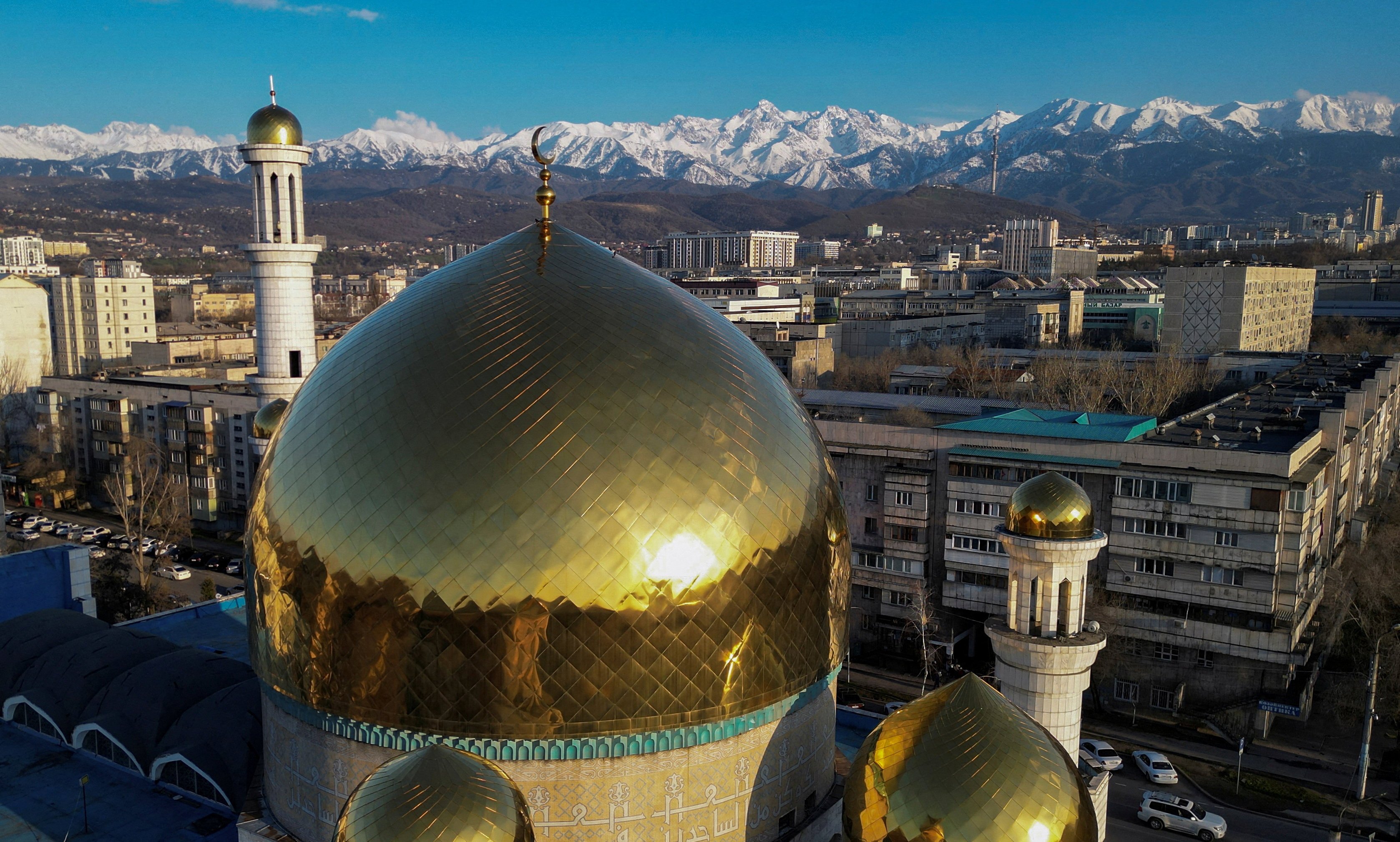 A drone view shows domes of the Central Mosque with the backdrop of the Tien Shan Mountains in Almaty, Kazakhstan, on April 7. Last year, Kazakhstan became a net importer of electricity as it struggled with a power deficit. Photo: Reuters