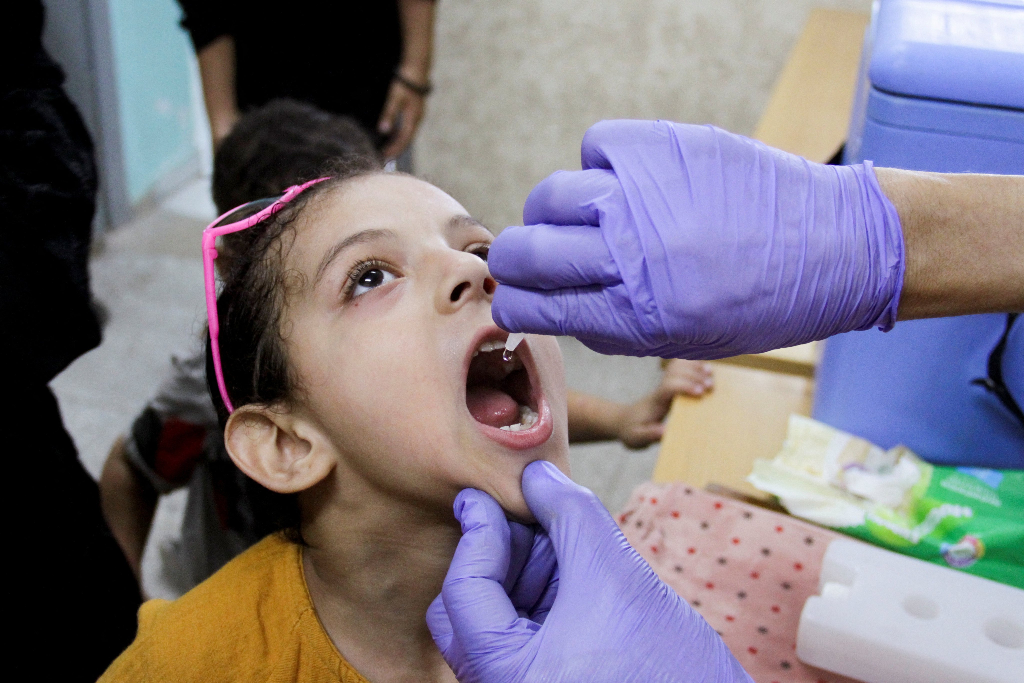 A Palestinian child is vaccinated against polio in Jabalia, in the northern Gaza Strip on September 10. Thousands of Palestinian children have missed important vaccinations because of the destruction wrought by Israel’s war against Hamas. Photo: Reuters