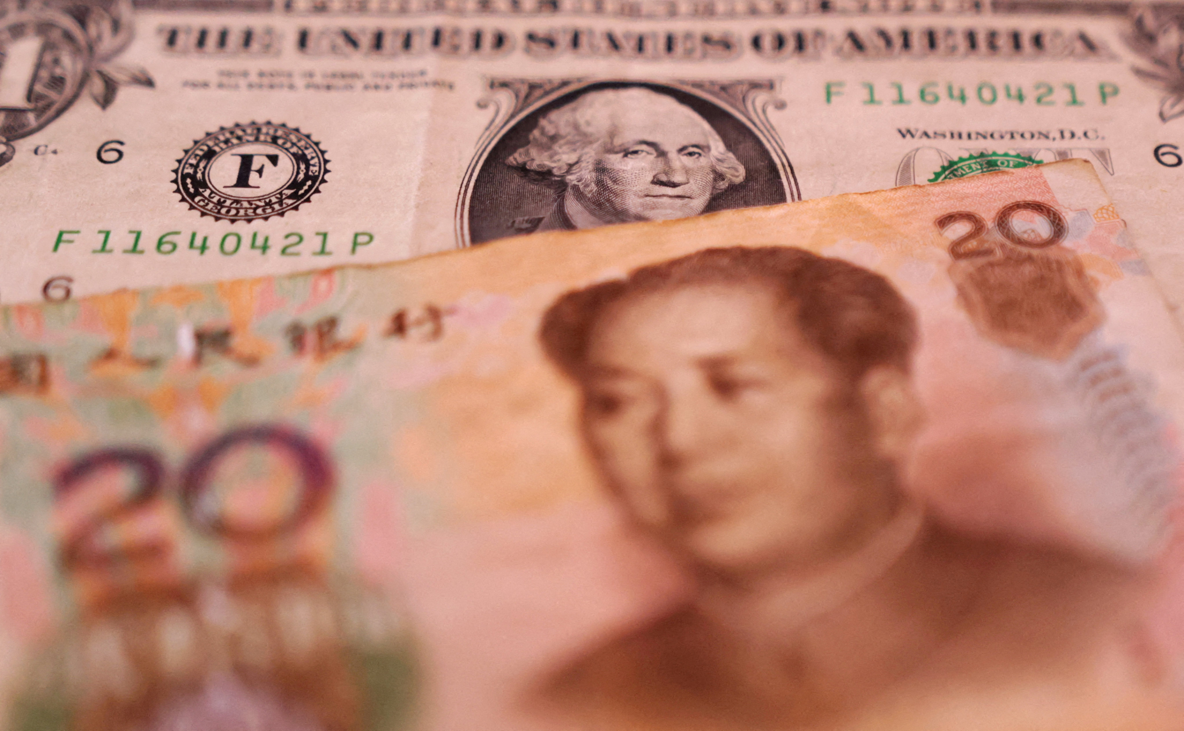 US dollar and Chinese yuan banknotes are seen in this illustration taken on January 30, 2023. Photo: Reuters 