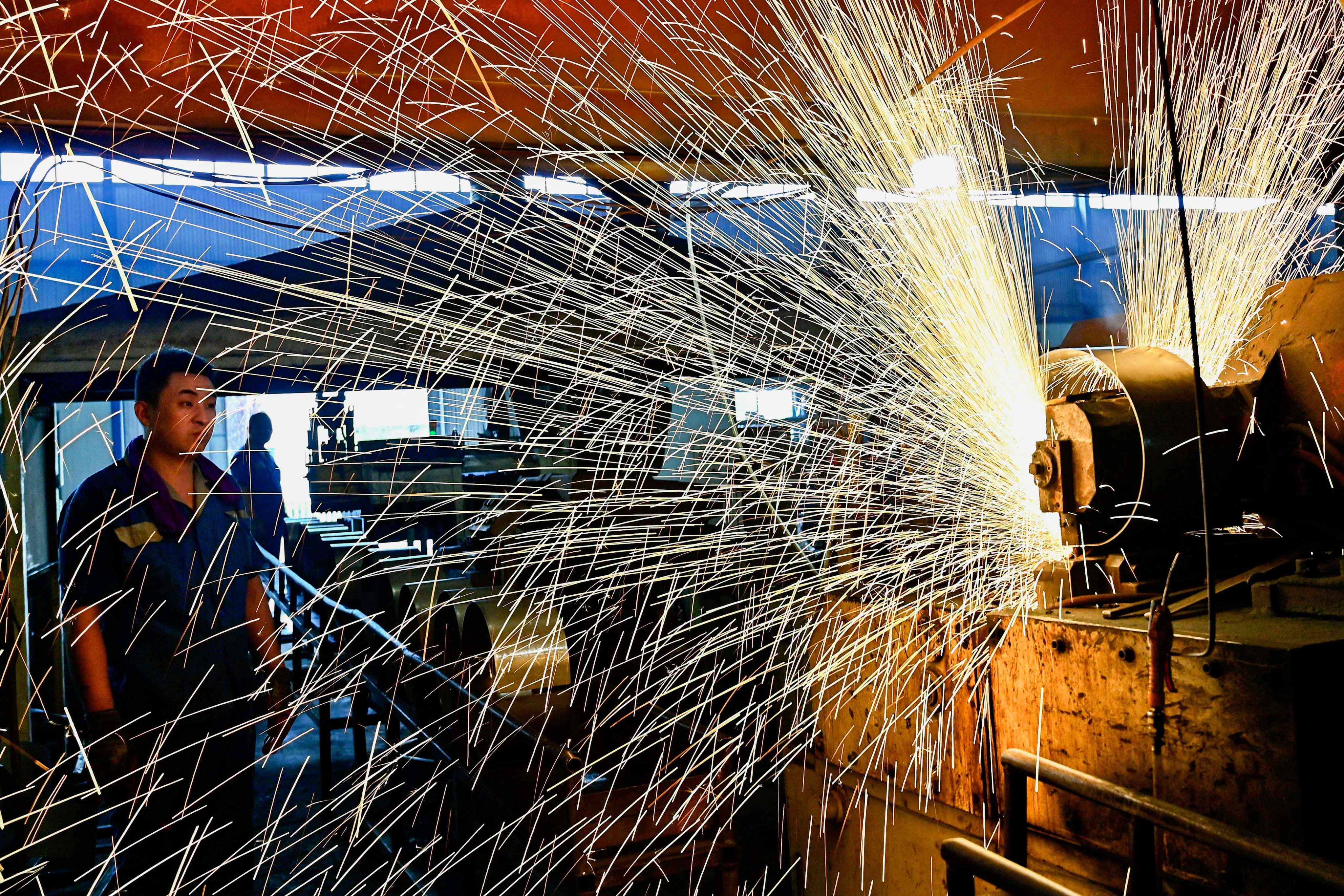 An employee works on a production line at a factory in China’s Shandong province. Industrial profits across the country dropped by nearly 18 per cent in August. Photo: AFP