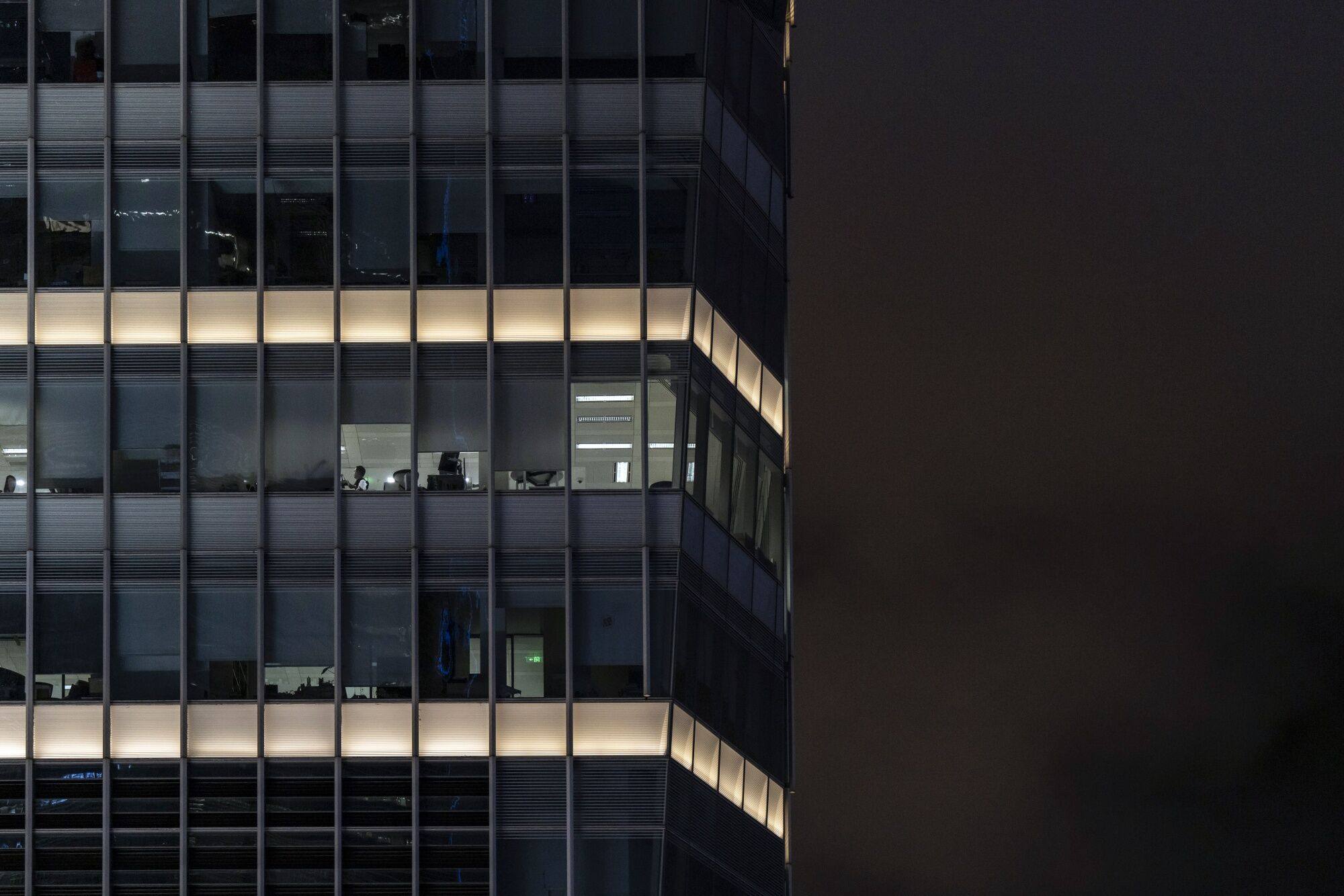 People work in offices in a commercial building in Pudong’s Lujiazui financial district in Shanghai on September 11. Photo: Bloomberg