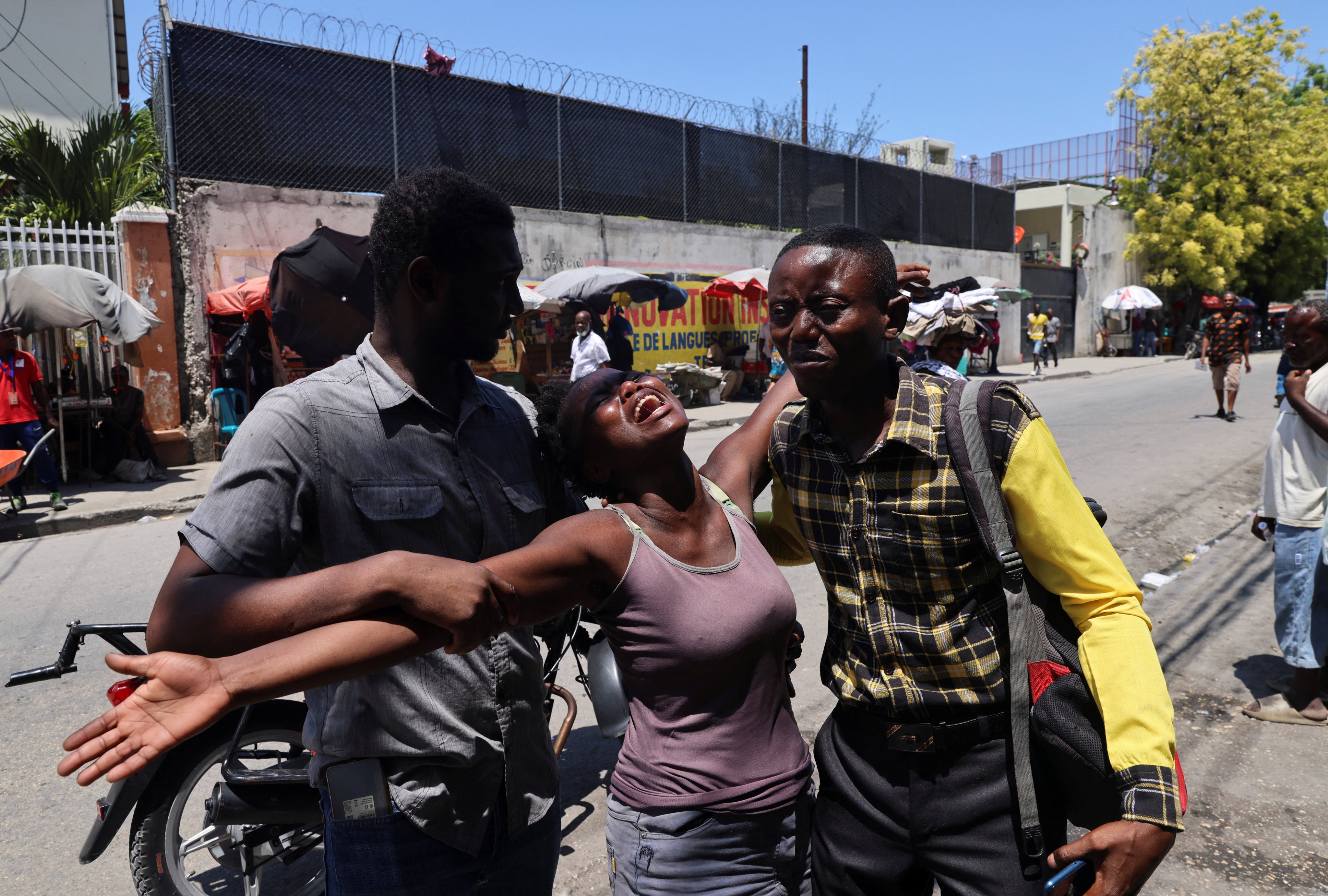 A woman reacts after seeing the body of her brother who was shot dead by unknown assailants in Port-au-Prince, Haiti, on September 9. Photo: Reuters