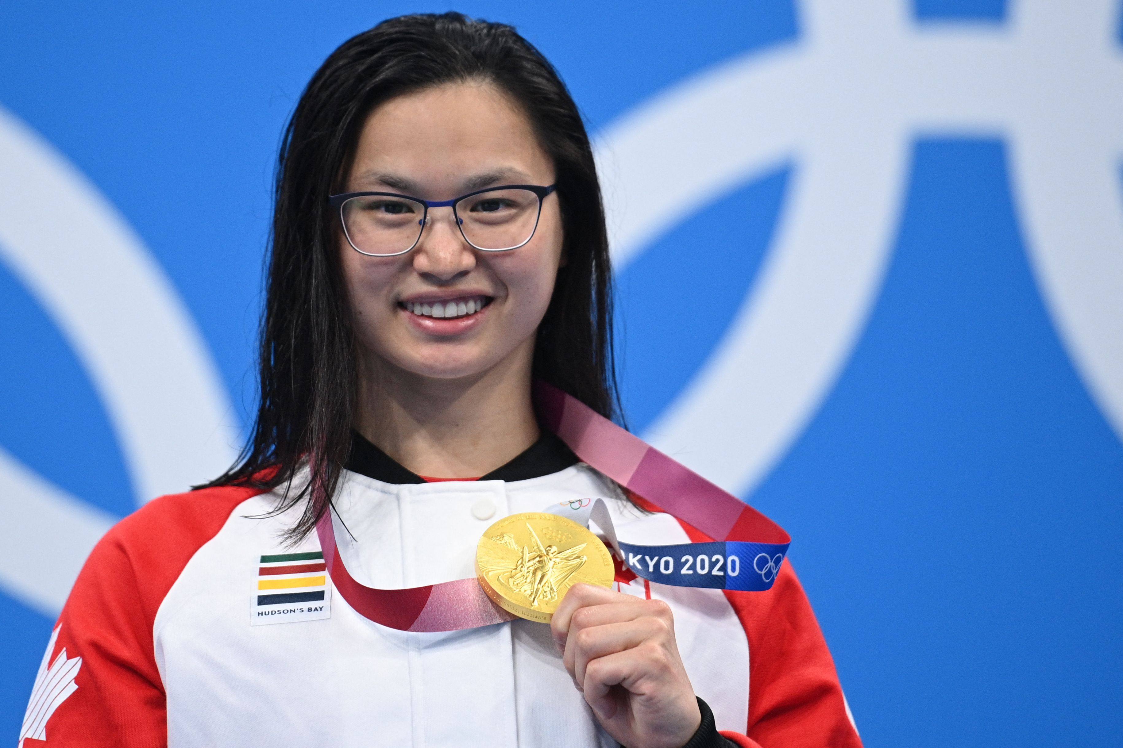 Canada’s Margaret Mac Neil poses with her gold medal after winning the women’s 100m butterfly at the Tokyo Olympics. Photo: AFP