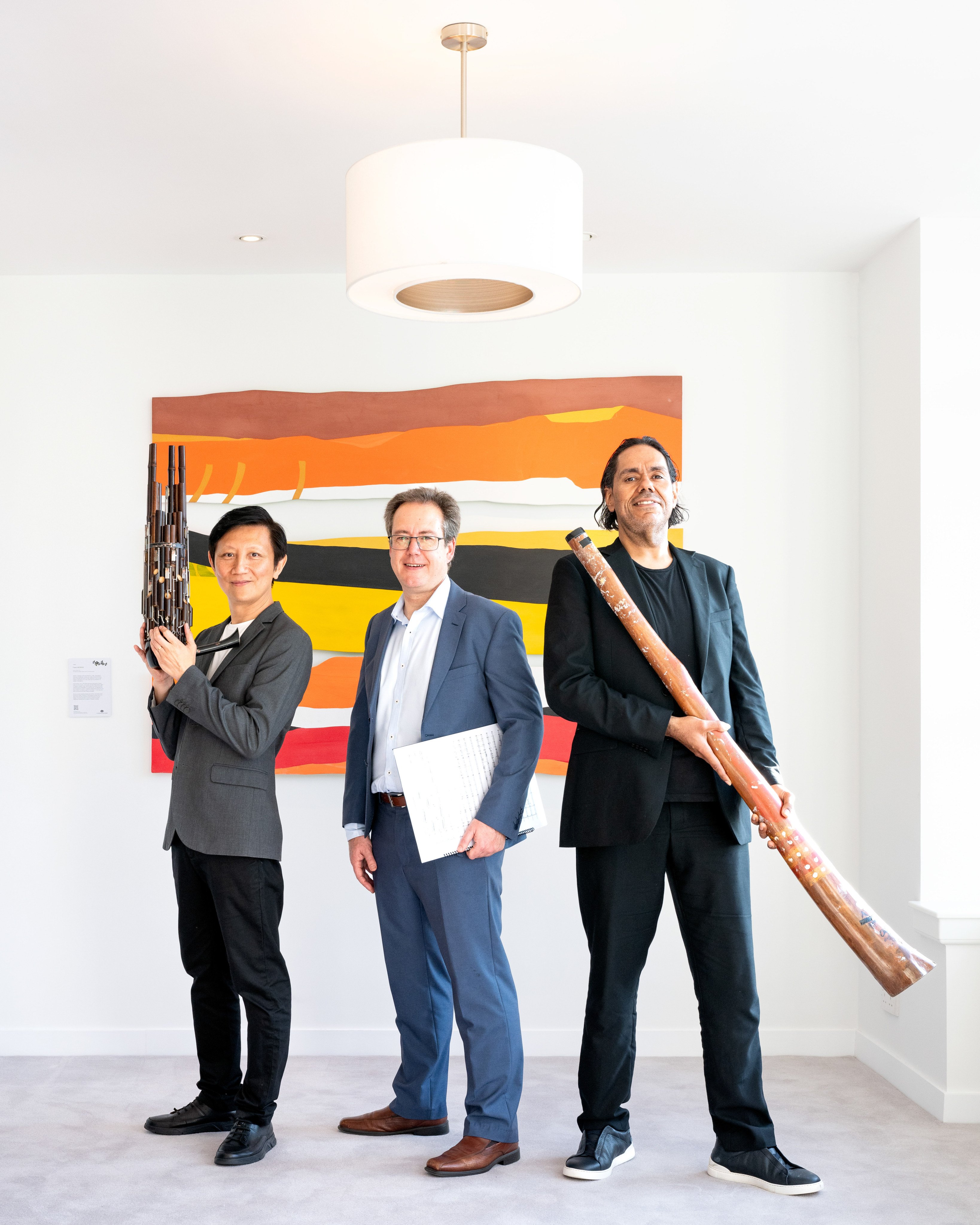 Sheng player Loo Sze-wang, conductor Luke Dollman and didgeridoo player William Barton, at the Australian Residence, Hong Kong, ahead of a performance of Dylan Crismani’s concerto for Sheng and Didgeridoo, Coming Together. Photo: Eugene Chan