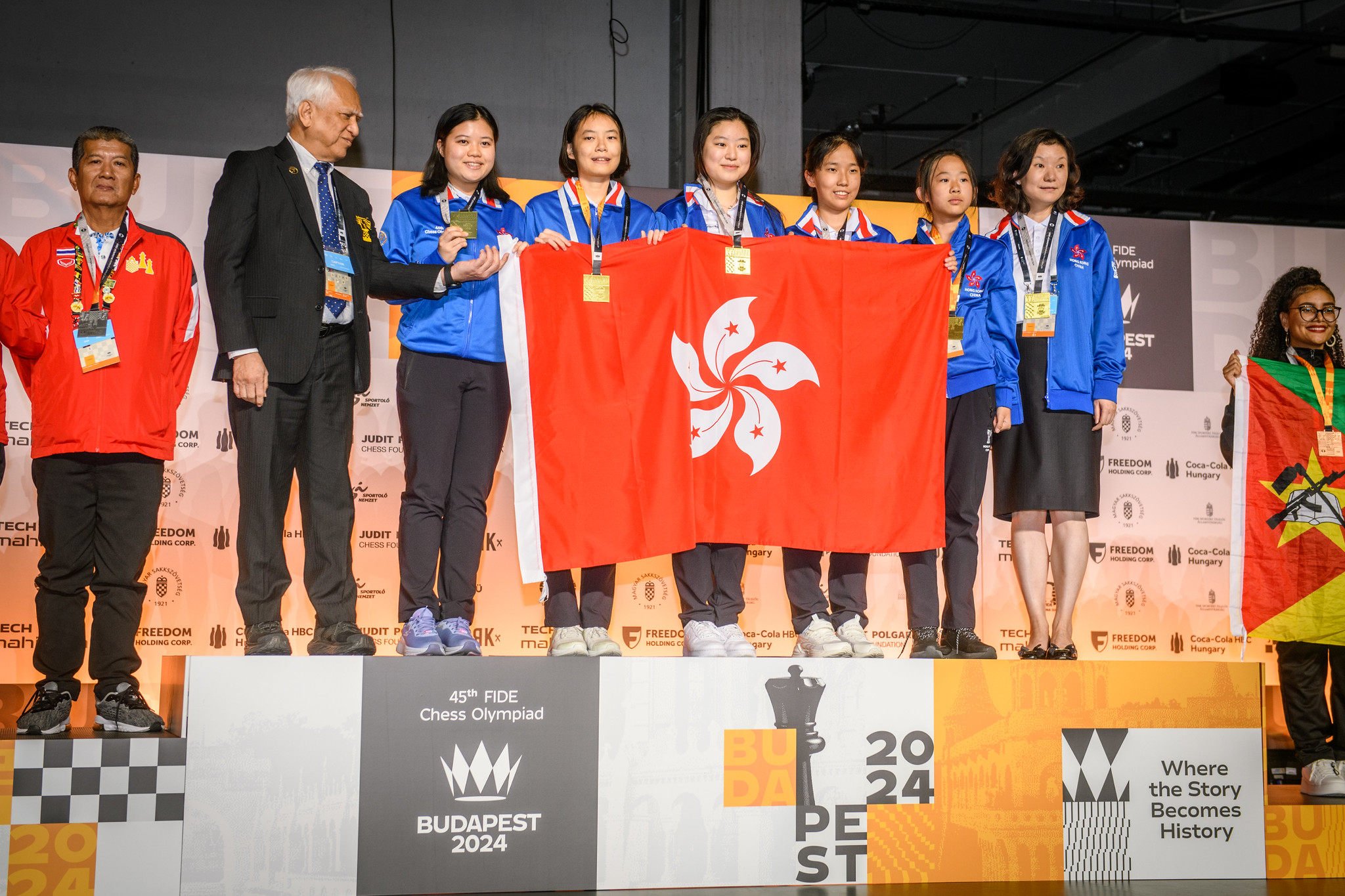 Hong Kong’s women’s team hold the city’s flag aloft on top of the podium after winning gold at the chess Olympiad. Photo: Hong Kong China Chess Federation