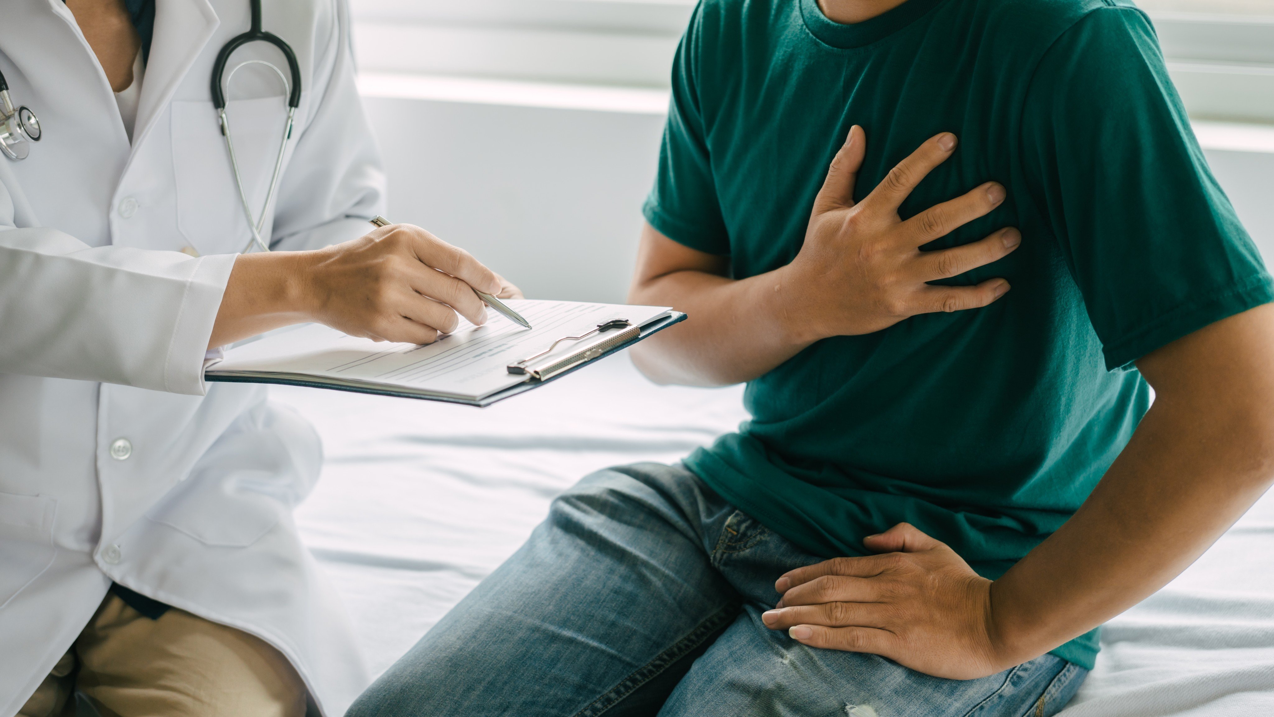 A male patient with heart pain speaks to a specialist in hospital. Malaysia’s proposal to expand paid services in public hospitals has sparked fears of a two-tier system. Photo: Shutterstock