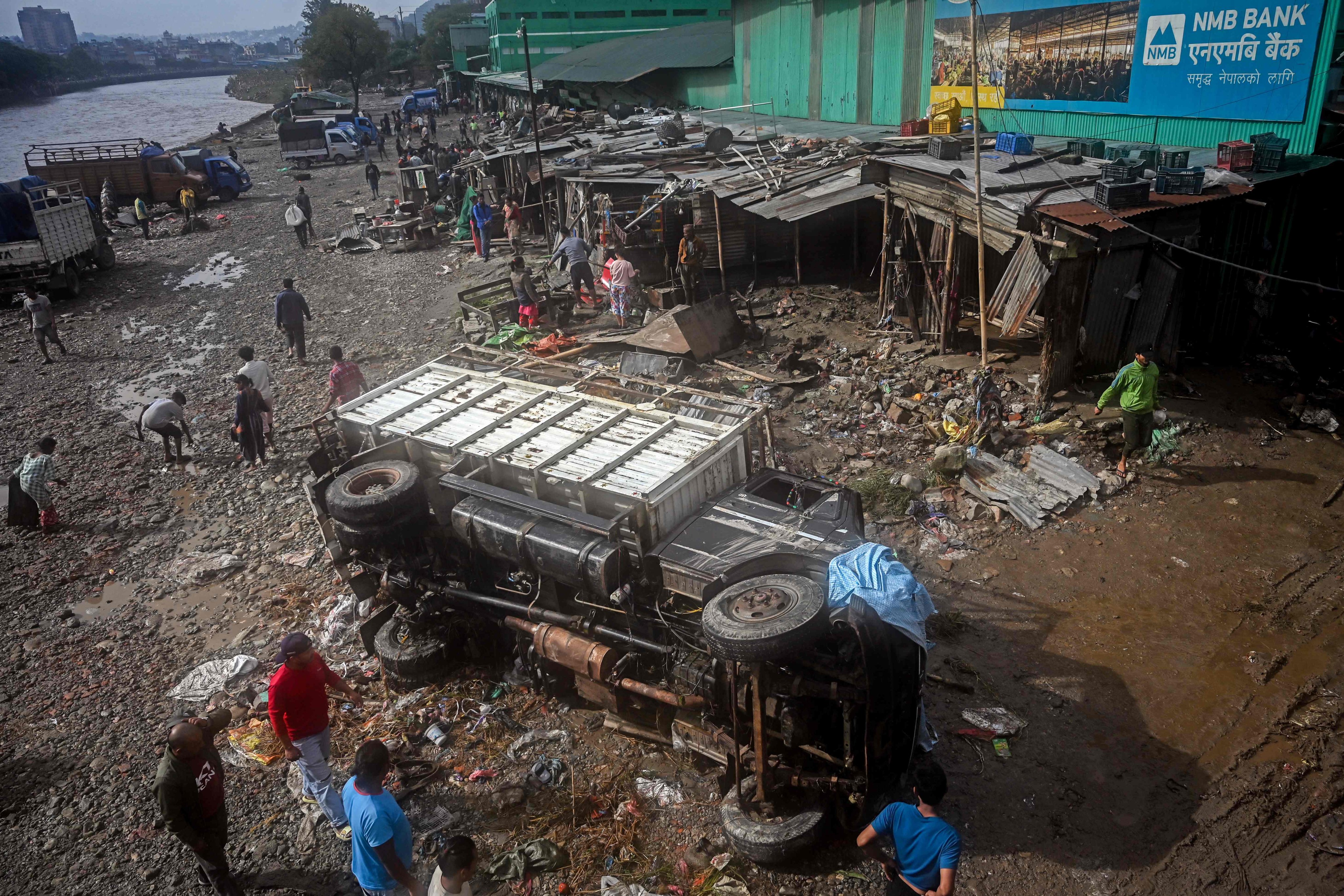 A damaged vehicle amid mud and debris in a flood-affected area in Kathmandu. Photo: AFP