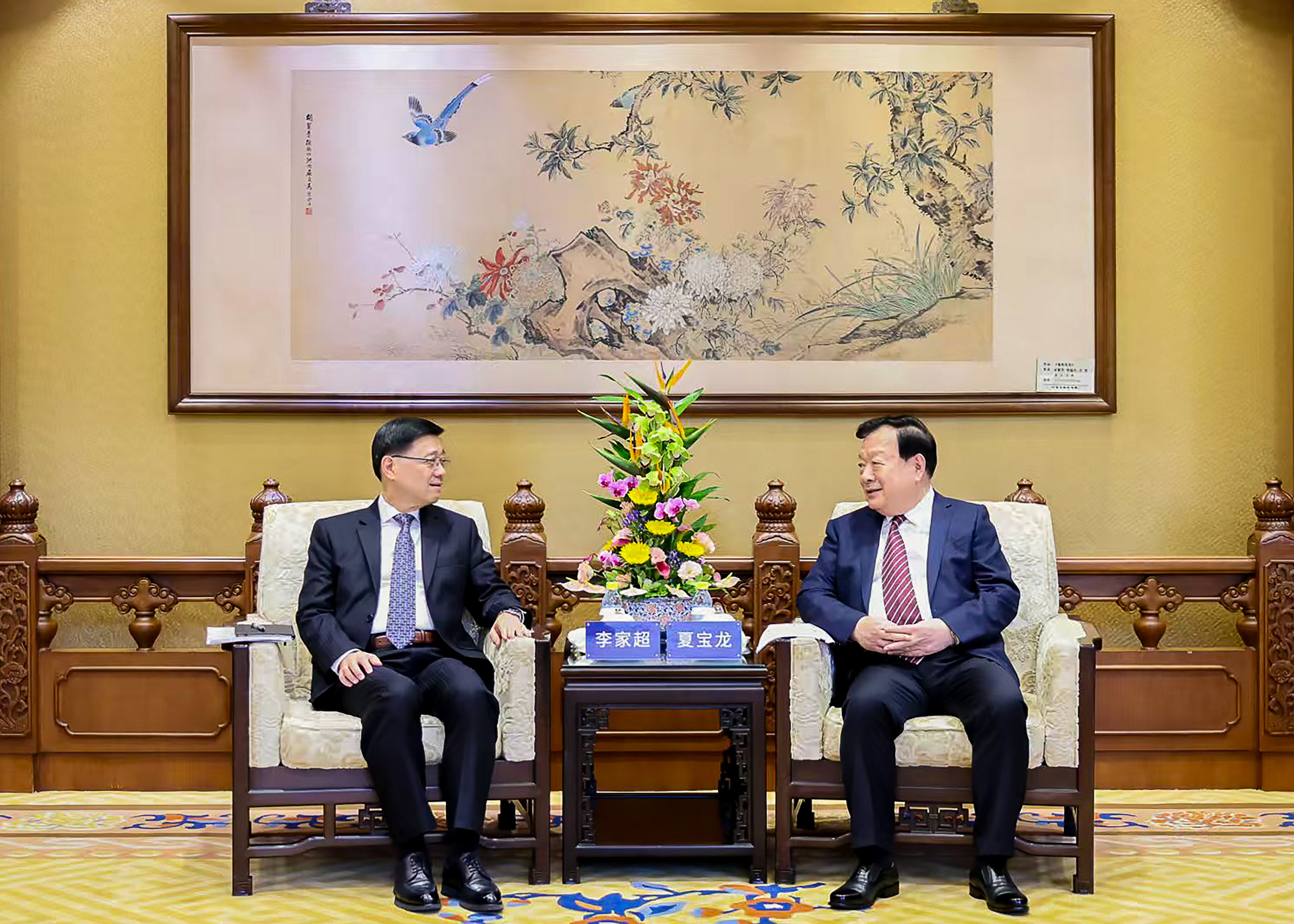 Hong Kong Chief Executive John Lee Ka-chiu, left, with Hong Kong and Macau Affairs Office director Xia Baolong in Beijing recently.    Photo: Hong Kong and Macau Affairs Office