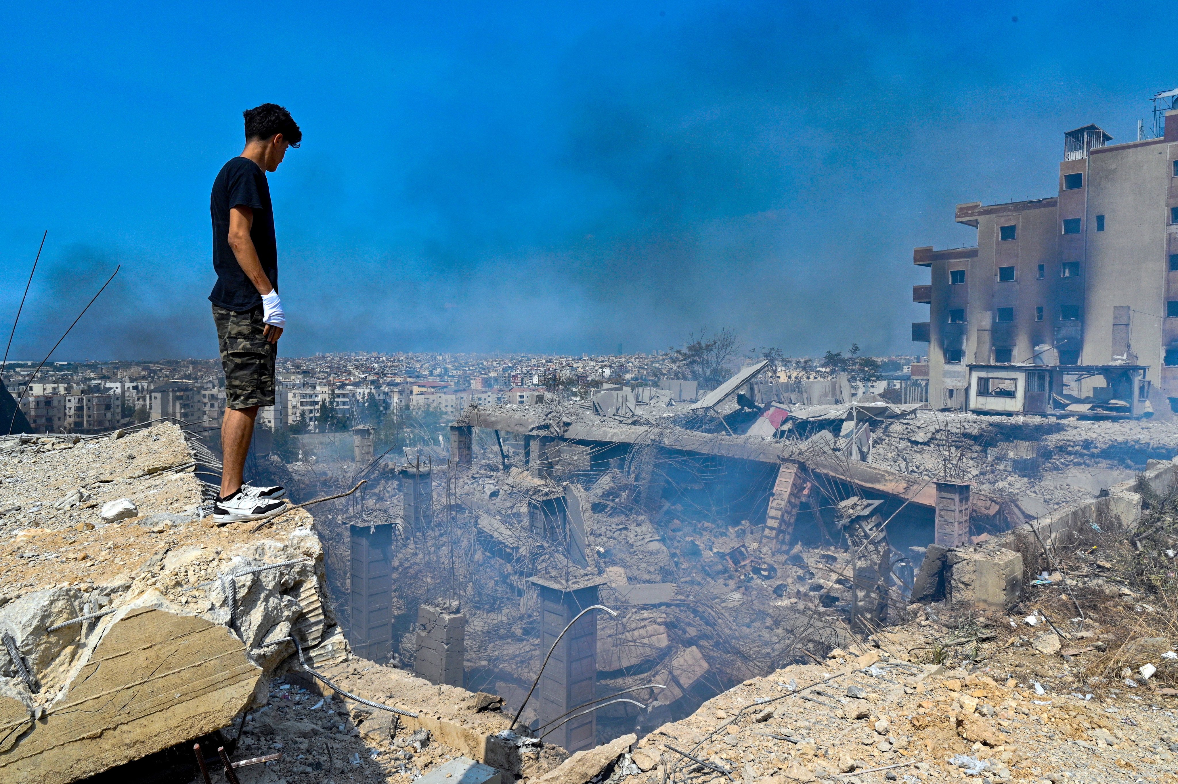 A man looks at rubble at the site of an Israeli airstrike southeast of Beirut, Lebanon on Saturday. Photo: EPA-EFE