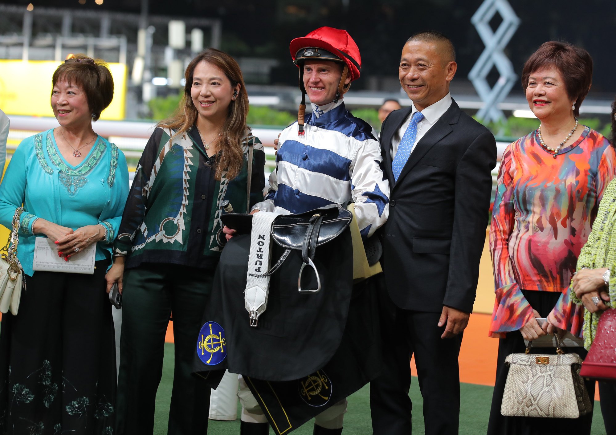 Jockey Zac Purton, trainer Danny Shum and connections celebrate Packing Power’s win at Happy Valley.