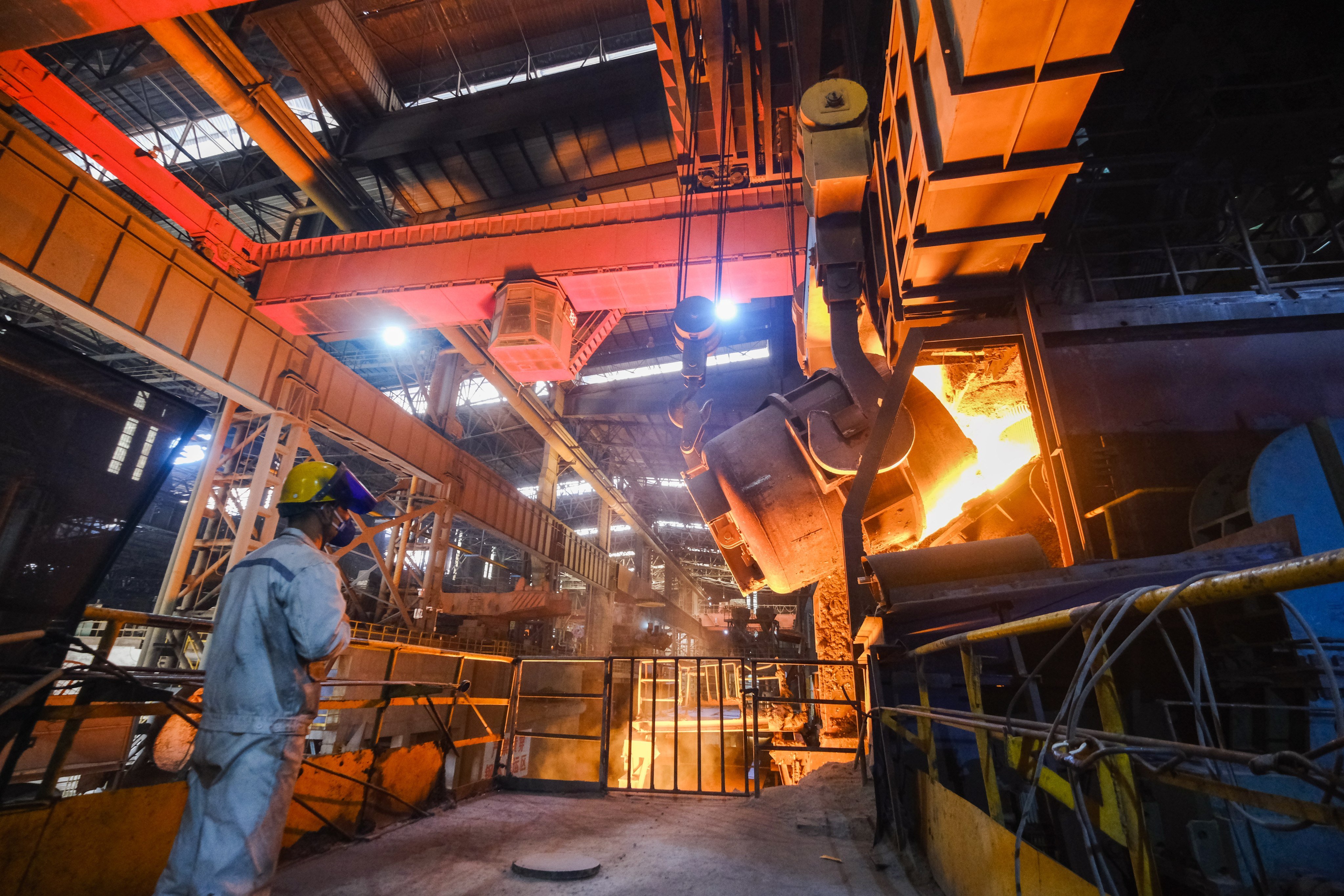 A staff member checks the operation of steel furnace at a special steel company in Xinfeng Town of Nanhu District, Jiaxing, Zhejiang province. Photo: EPA-EFE