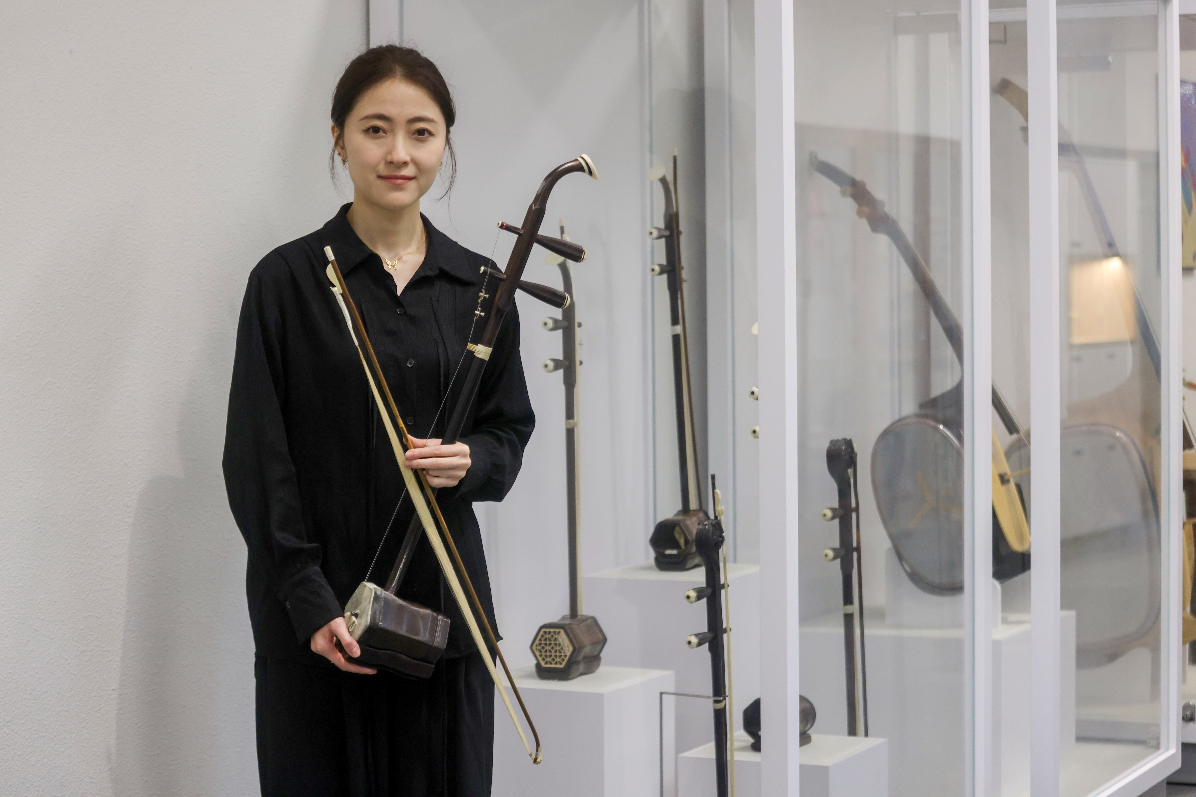 Hong Kong Chinese Orchestra erhu player Song Hui with her instrument. Often compared to the violin, it is a relative newcomer compared to another stringed instrument, the Chinese zither, or guqin. Photo: Jonathan Wong