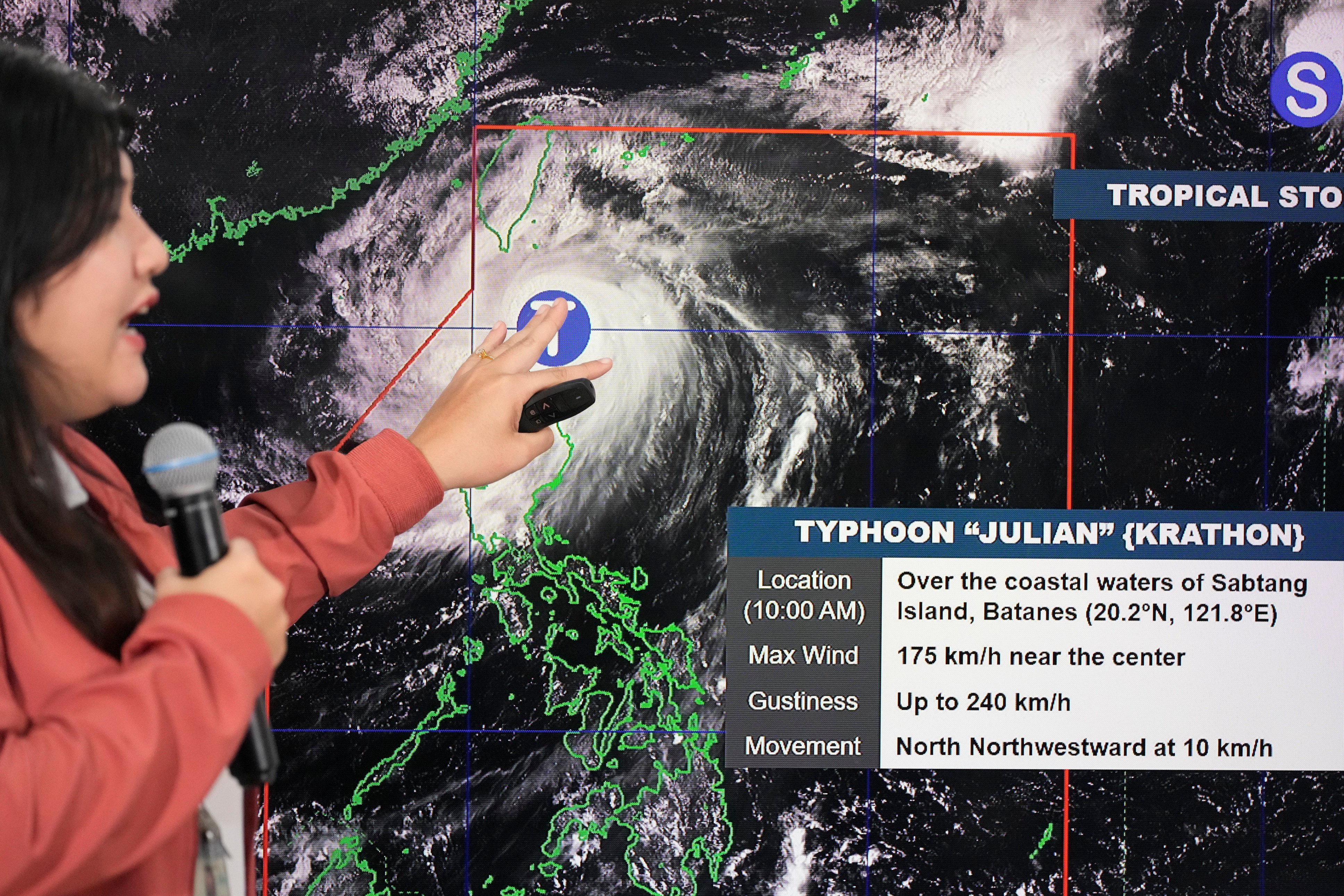 A Filipino forecaster points at an electronic board showing the strength of Typhoon Krathon on Monday. Photo: AP