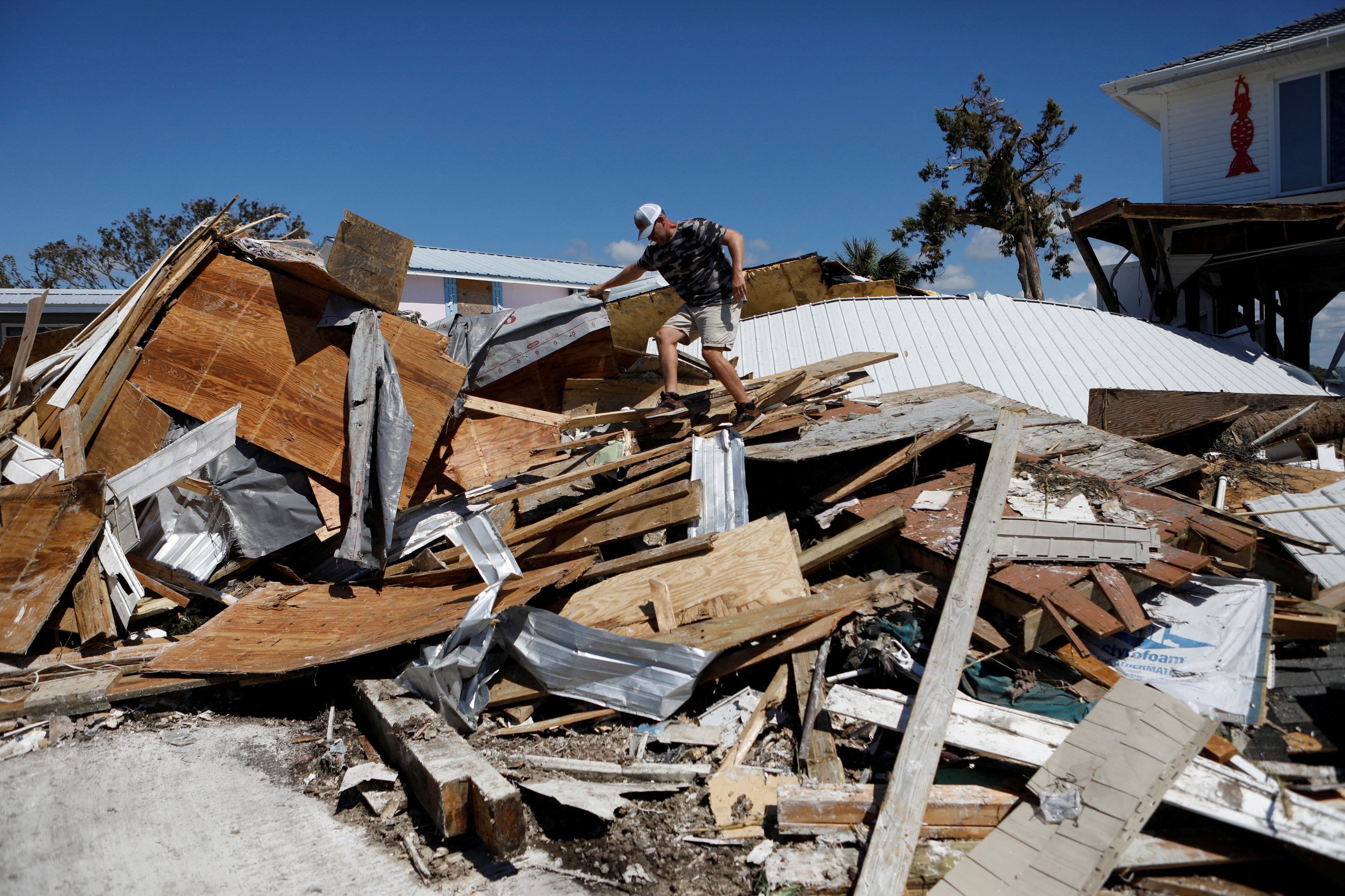 A resident of Keaton Beach, Florida, works to recover his belongings from his home. Photo: Reuters