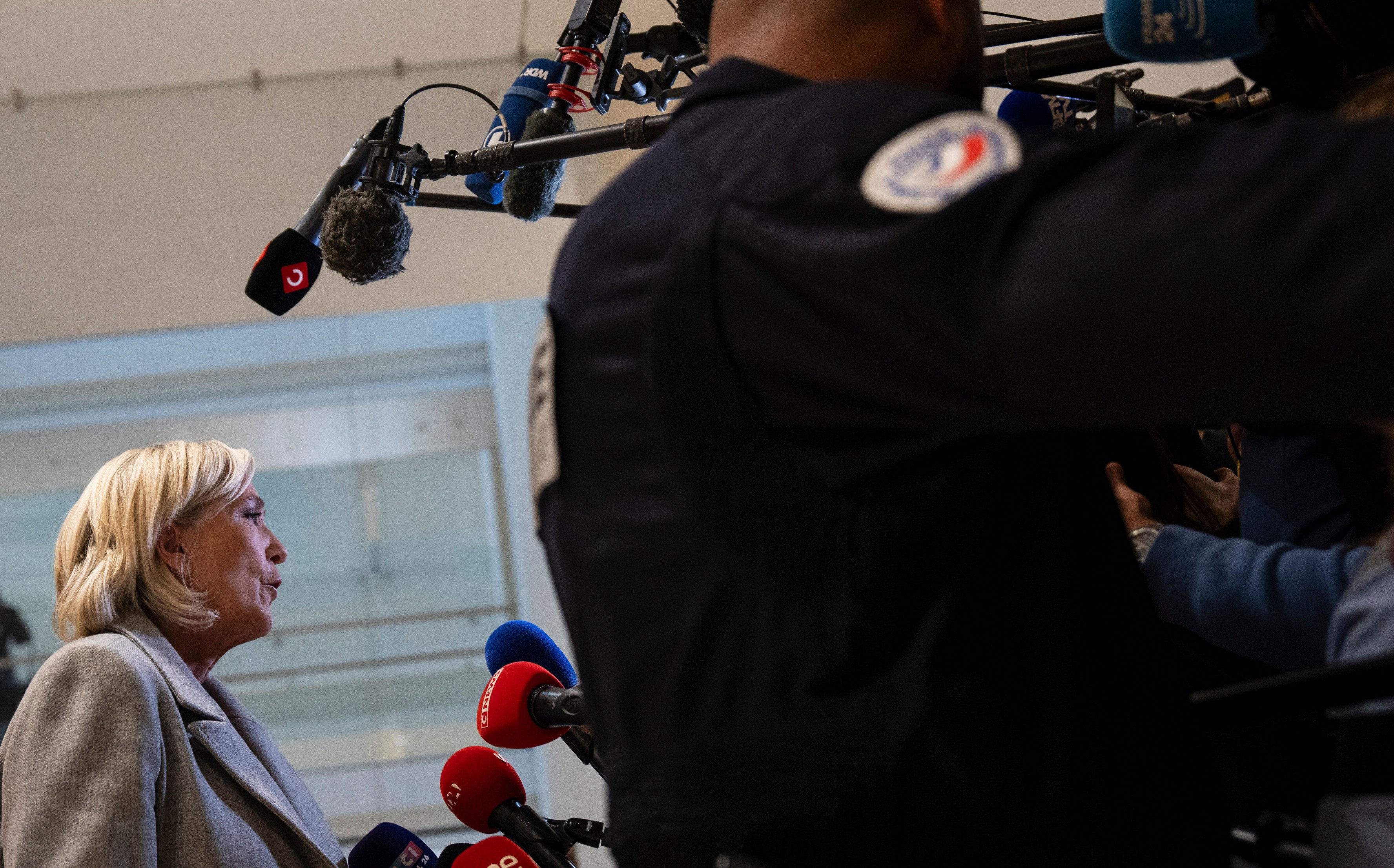 French far-right leader Marine Le Pen speaks to the media as she arrives at court in Paris on Monday. Photo: AP