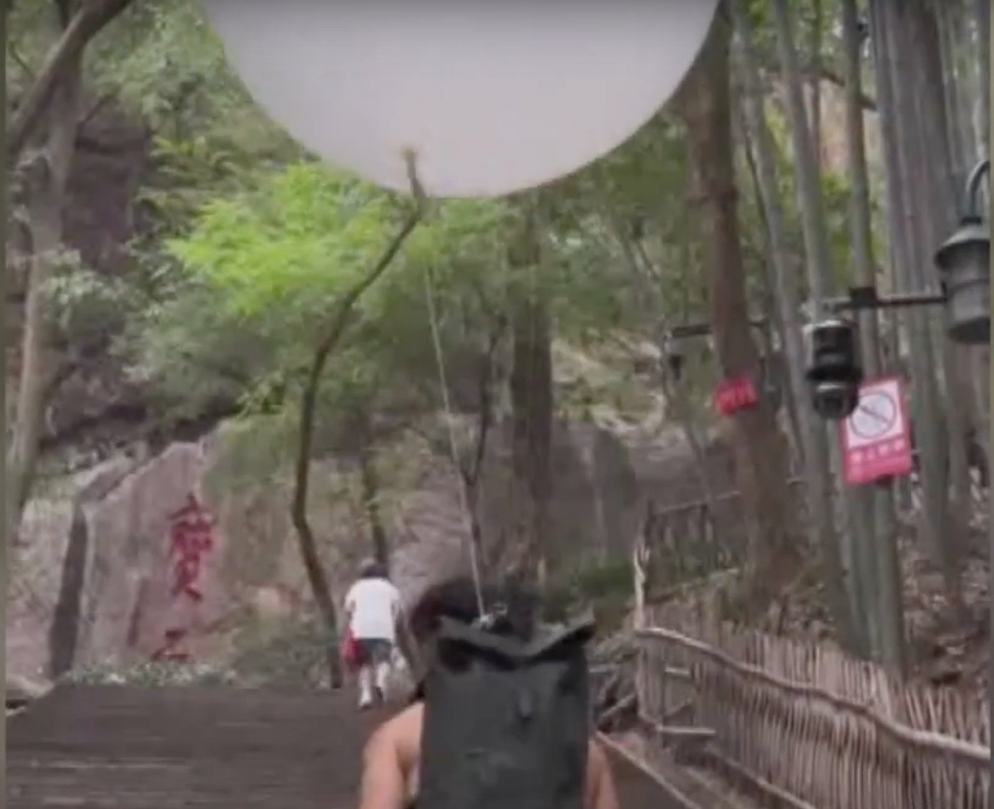 Pu sets off on a hike with a huge helium-filled balloon floating above his backpack. Photo: SETN