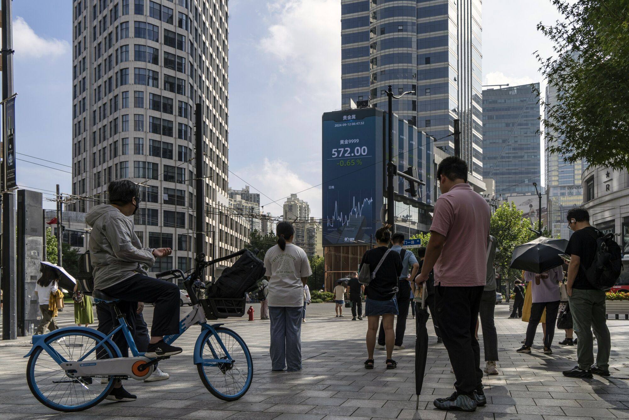 A screen displayed financial information in Shanghai. Photo: Bloomberg 