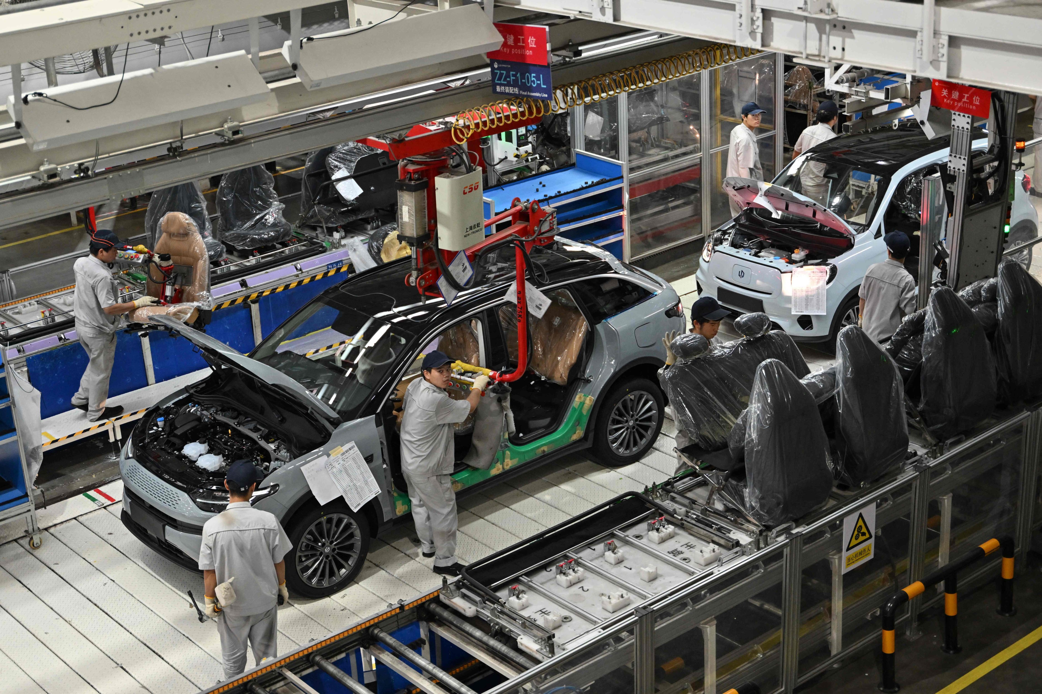 Employees work on an EV production line at a Leapmotor factory in Jinhua, in China’s eastern Zhejiang province, on September 18, 2024. Photo: AFP