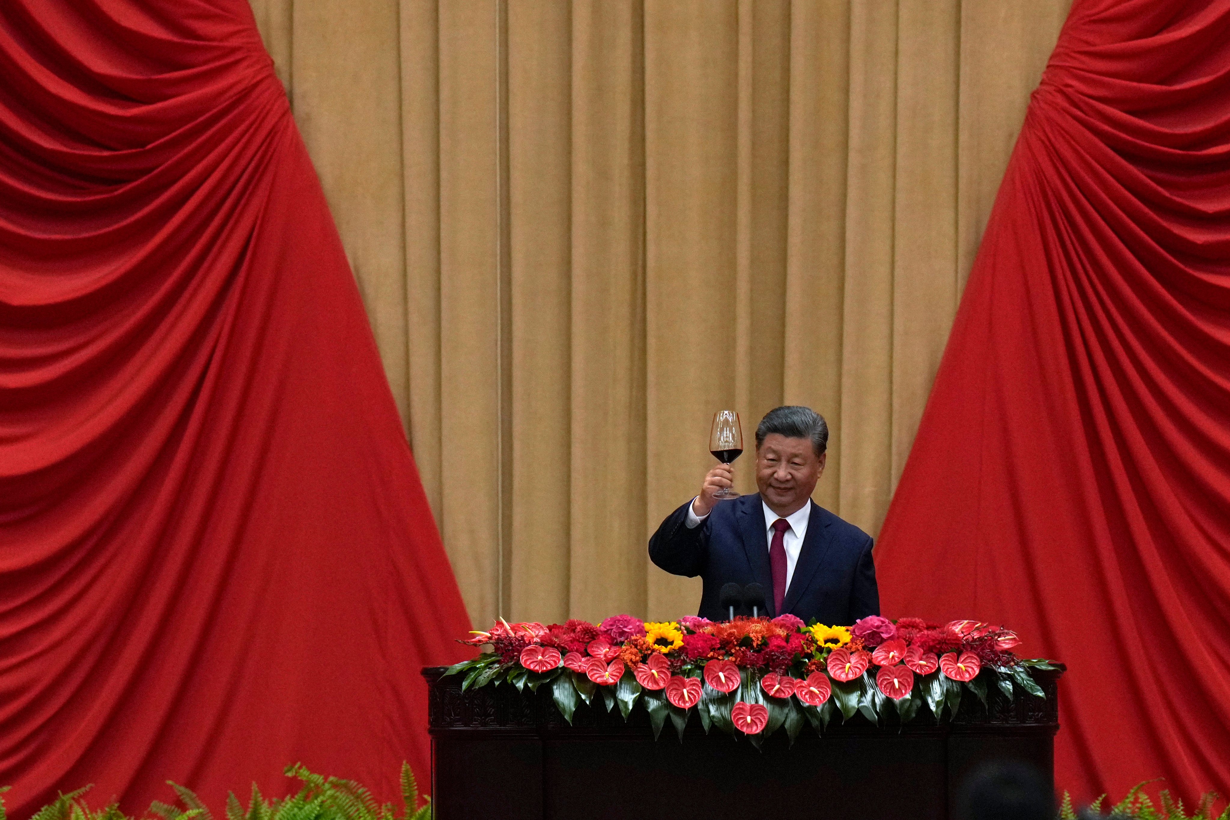 President Xi Jinping makes a toast on stage after delivering his speech at a dinner marking the 75th anniversary of the founding of the People’s Republic of China, at the Great Hall of the People in Beijing on Monday. Photo: AP