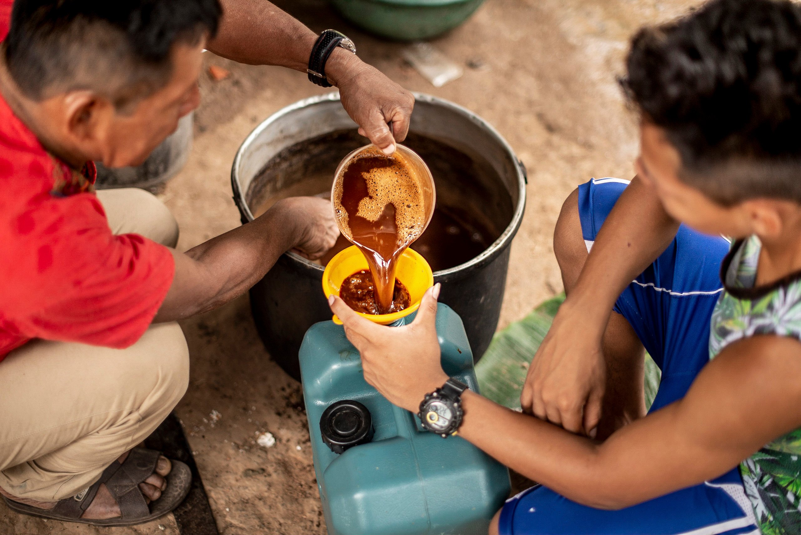 A shaman in Peru puts a broth of ayahuasca into a cup. Photo: Getty Images