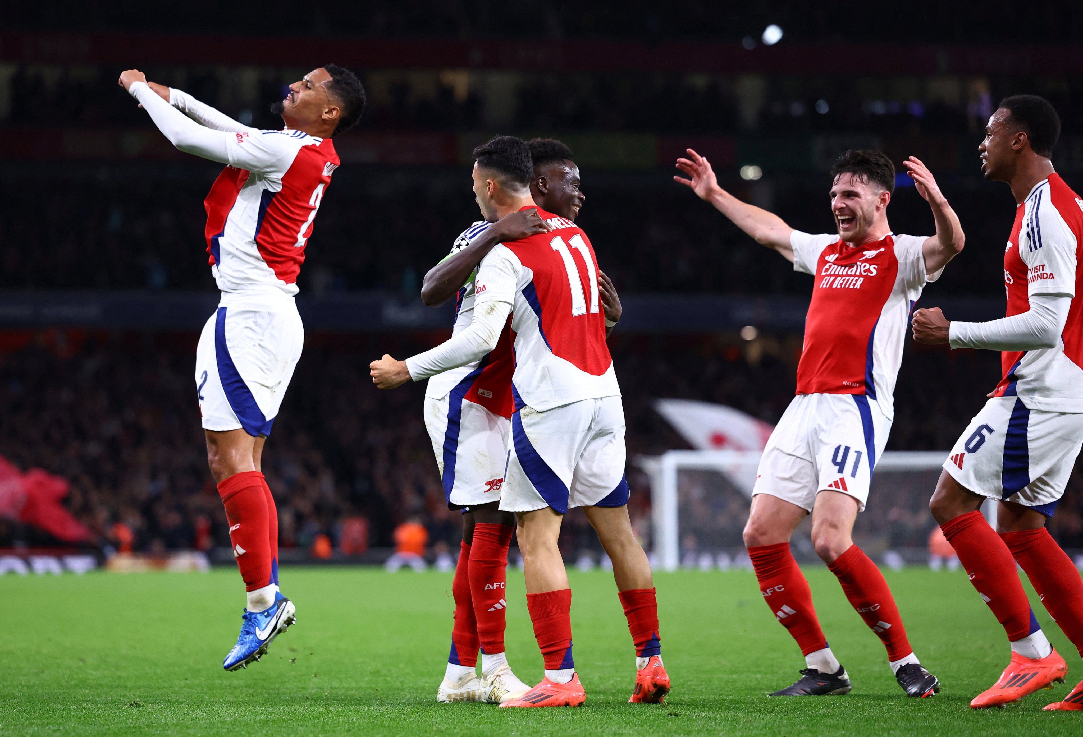 Arsenal’s Bukayo Saka celebrates with his teammates as his goal helped seal a 2-0 victory over Paris Saint-Germain in the Uefa Champions League. Photo: Reuters