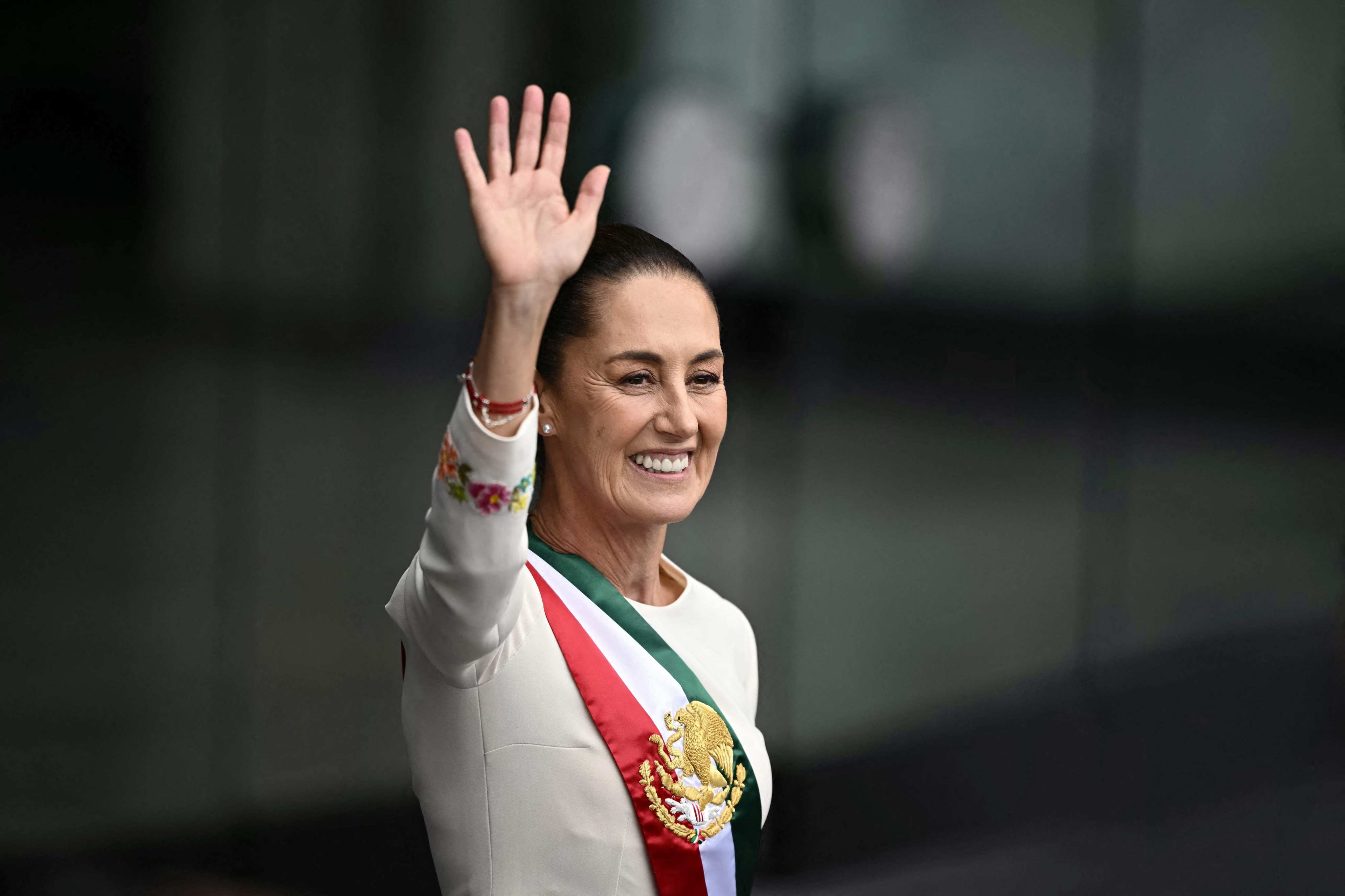 Mexico’s President Claudia Sheinbaum waves at the crowd as she leaves the Congress of the Union after her inauguration ceremony in Mexico City on Tuesday. Photo: AFP