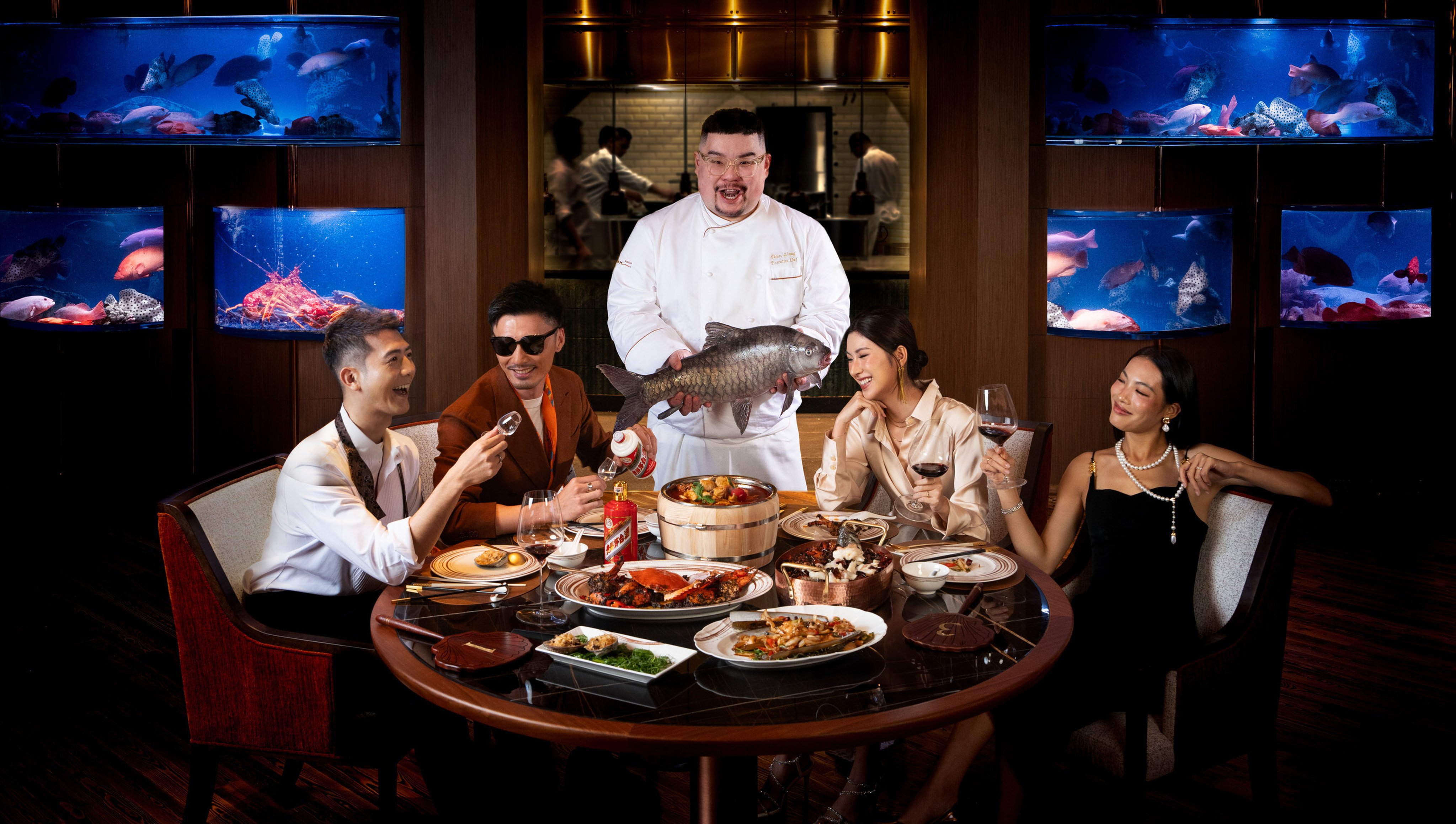 Drunken Fish executive chef Henry Zhang Zhicheng (centre) holds a fish at the restaurant in Macau, one of nine new places we recommend checking out in Hong Kong and Macau this October. Photo: Wynn Macau