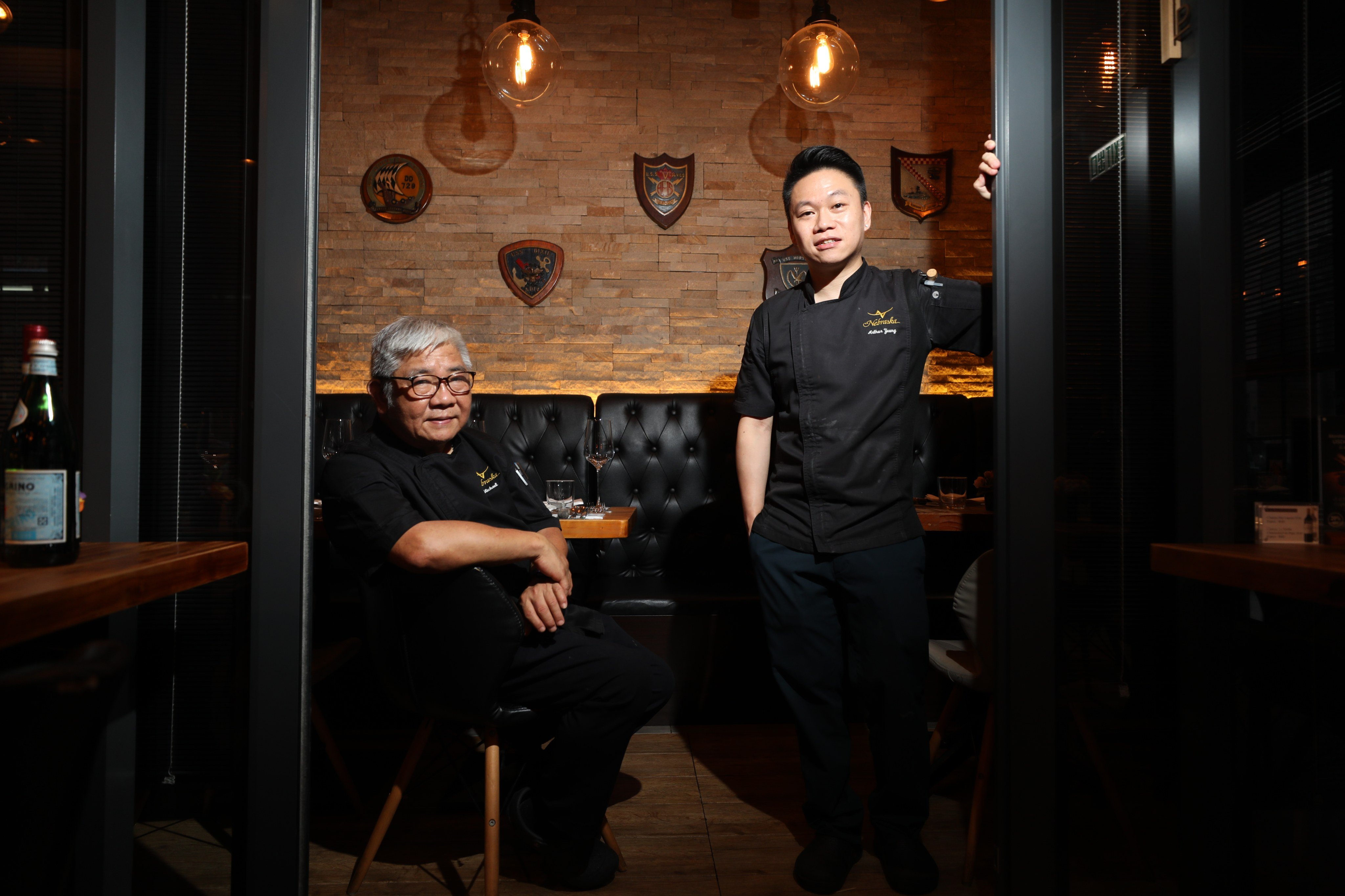 Owners of Nebraska Steakhouse, Michael Yeung (left) and his son Arthur Yeung, are planning to close their restaurant in Wan Chai. Photo: Xiaomei Chen