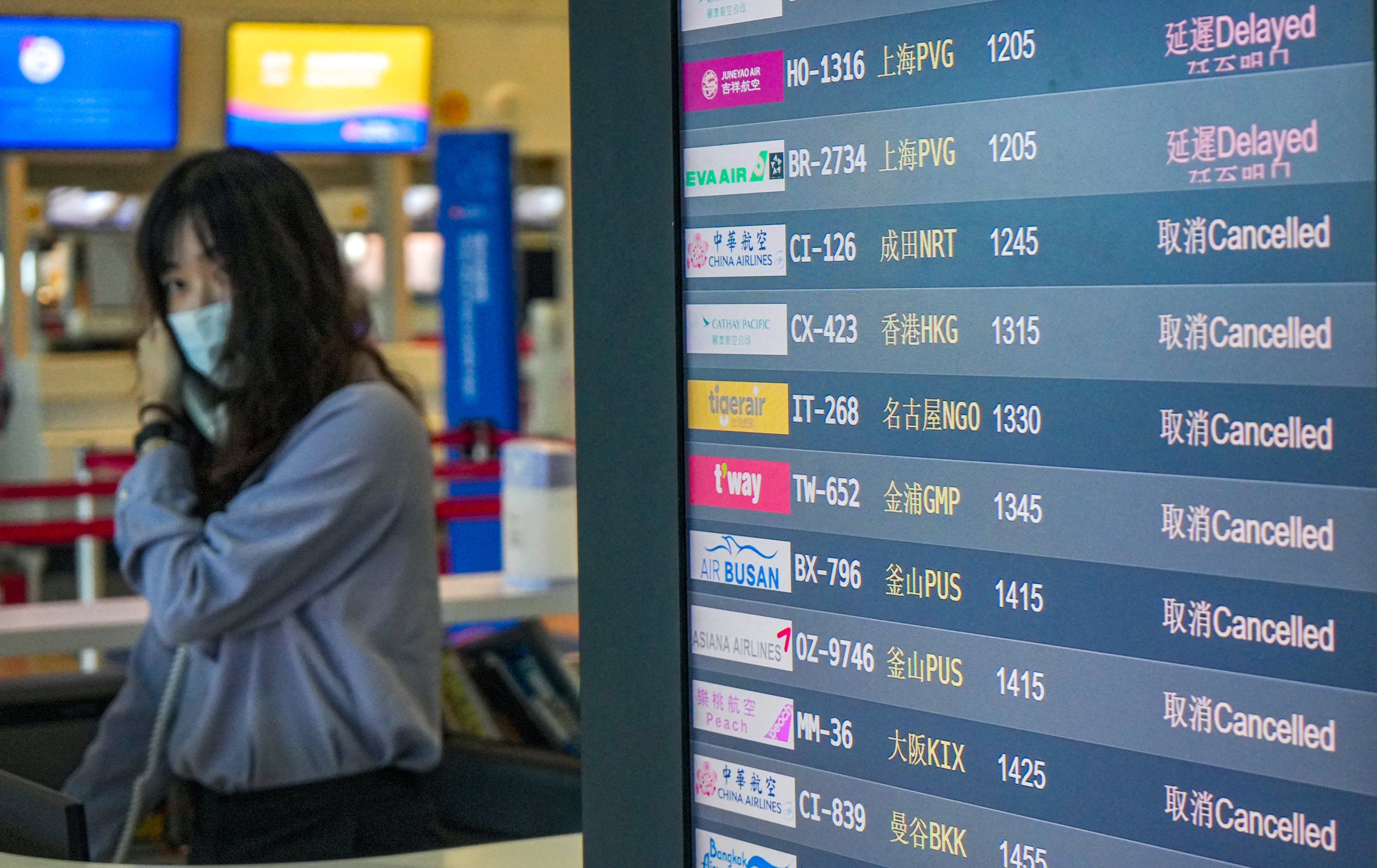 A screen showing flight status at Kaohsiung International Airport. Photo: AFP