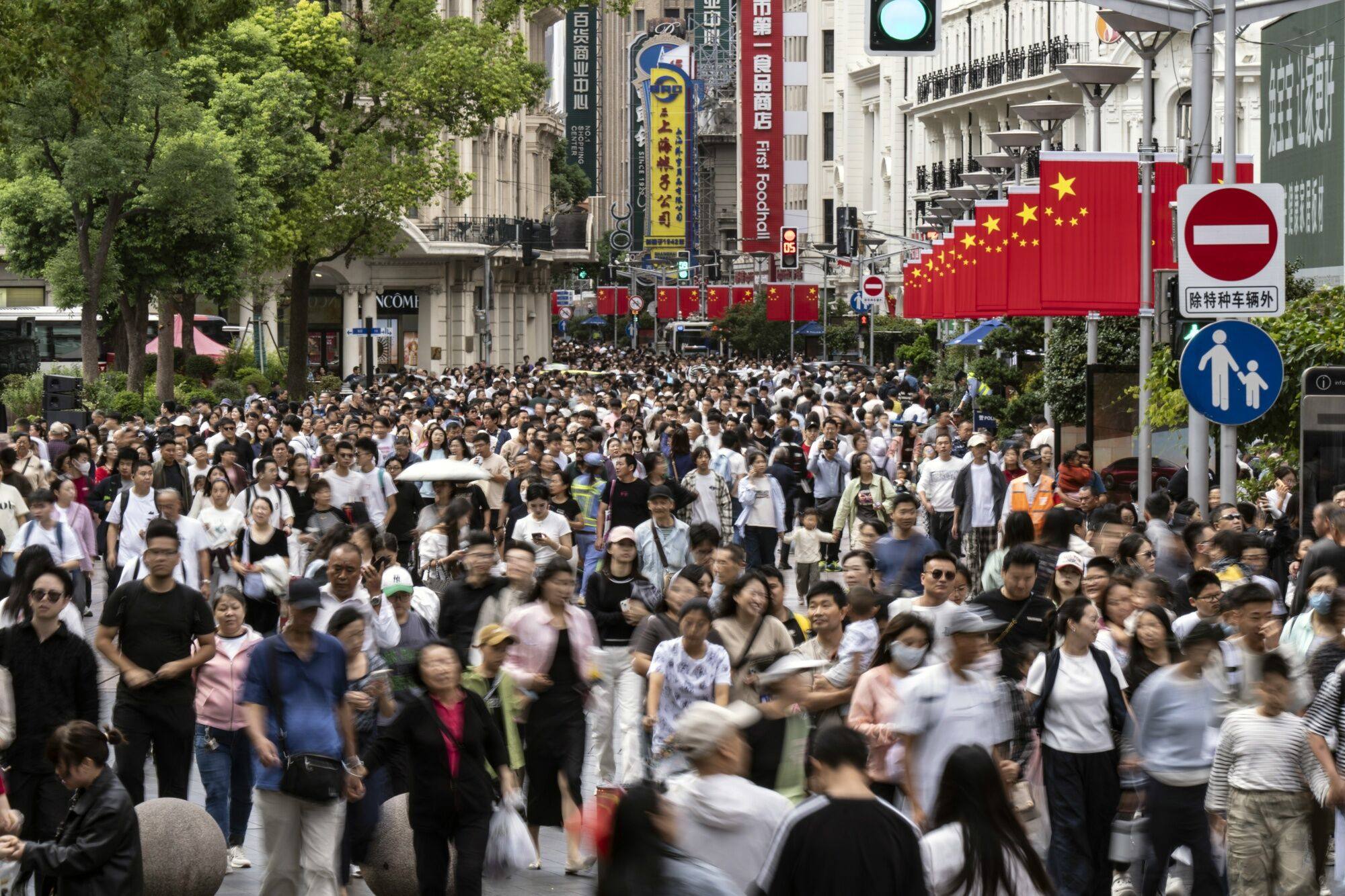 Shoppers on Nanjing East Road in Shanghai on October 2. While the stimulus measures announced by the government have lifted market sentiment, there is scepticism about whether they will translate to the real economy. Photographer: Bloomberg