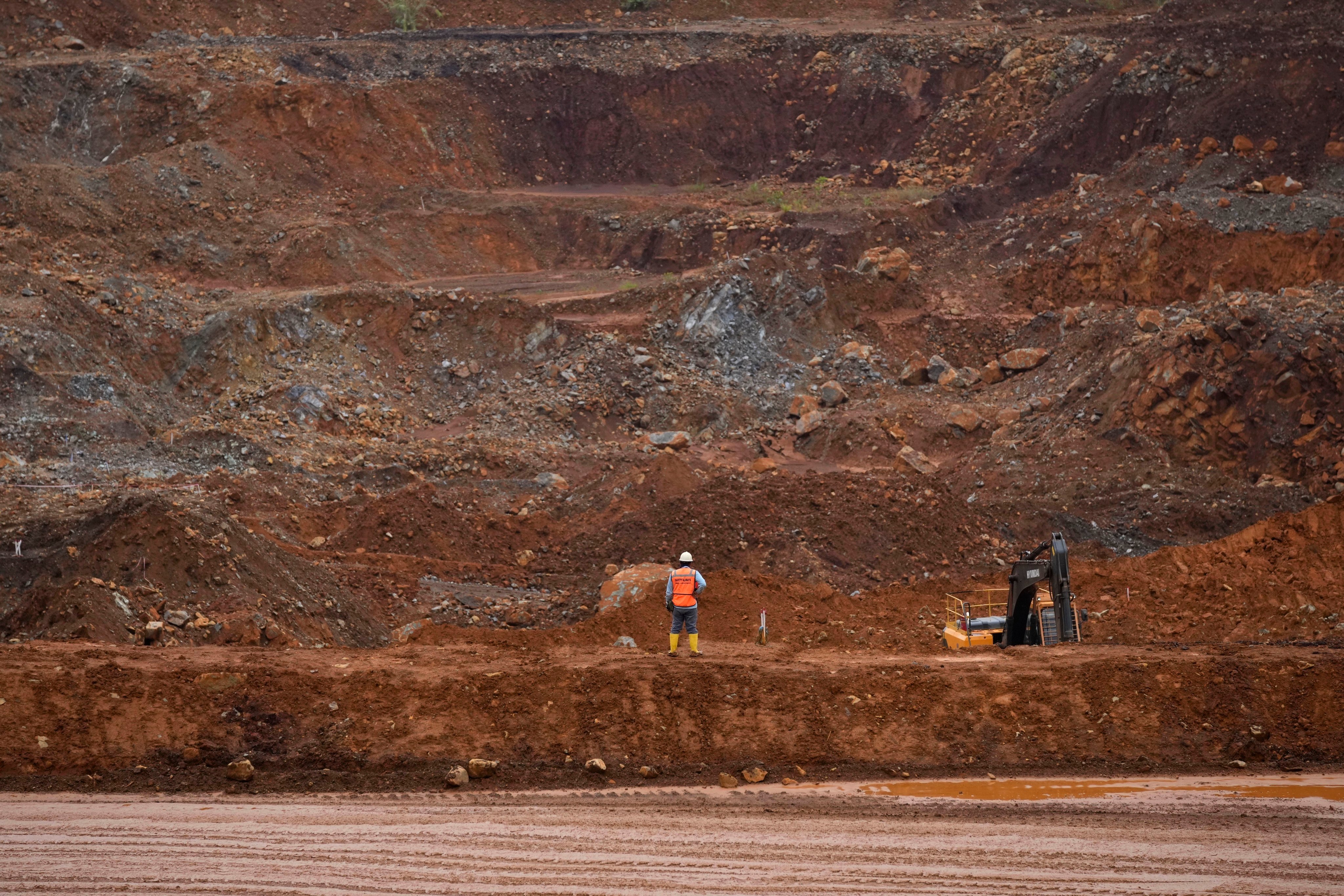 A worker stands near a mining pit in South Sulawesi, Indonesia. Photo: AP