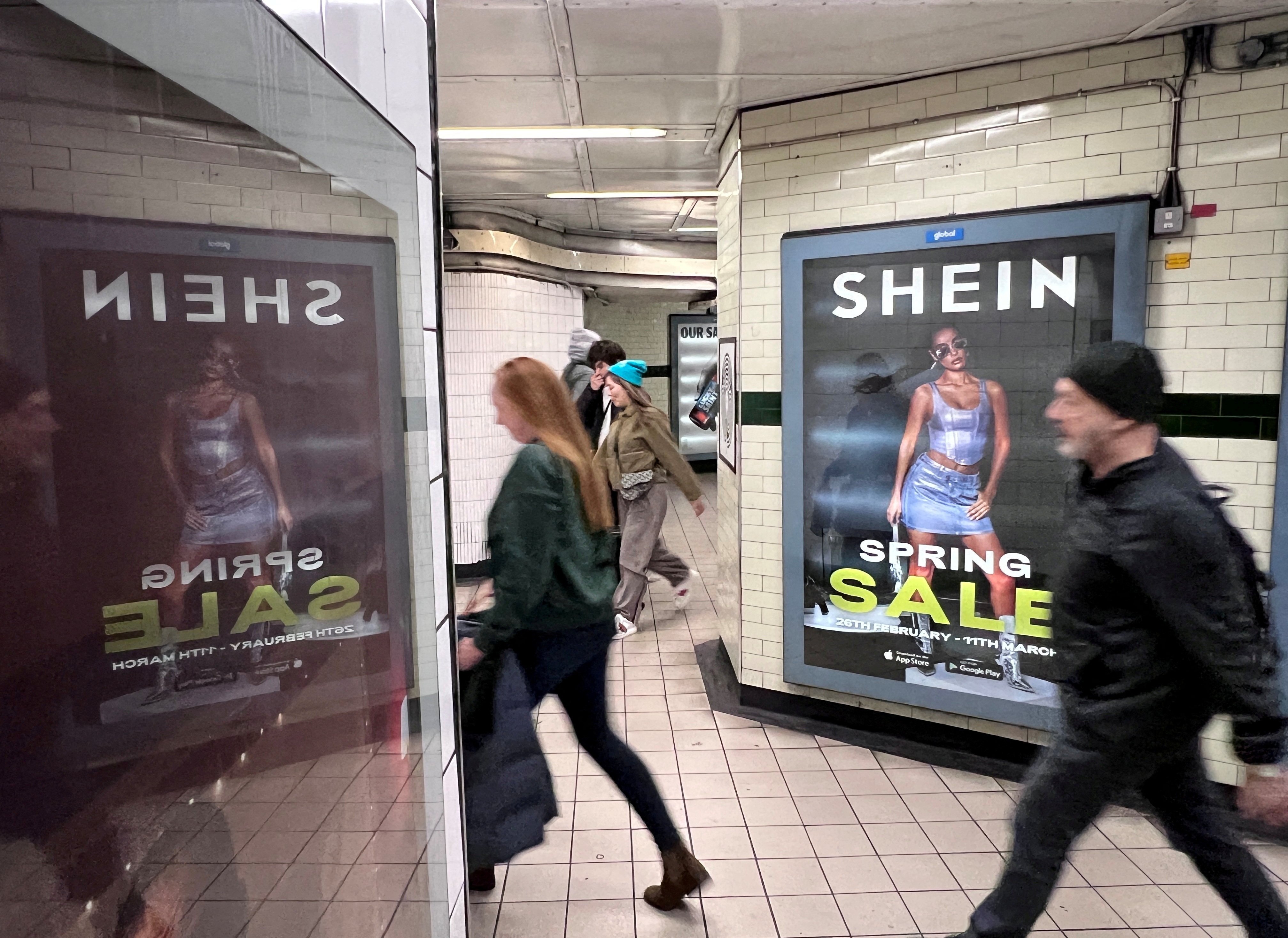 People walk past a Shein advertisement in London in April 2024. Photo: Reuters