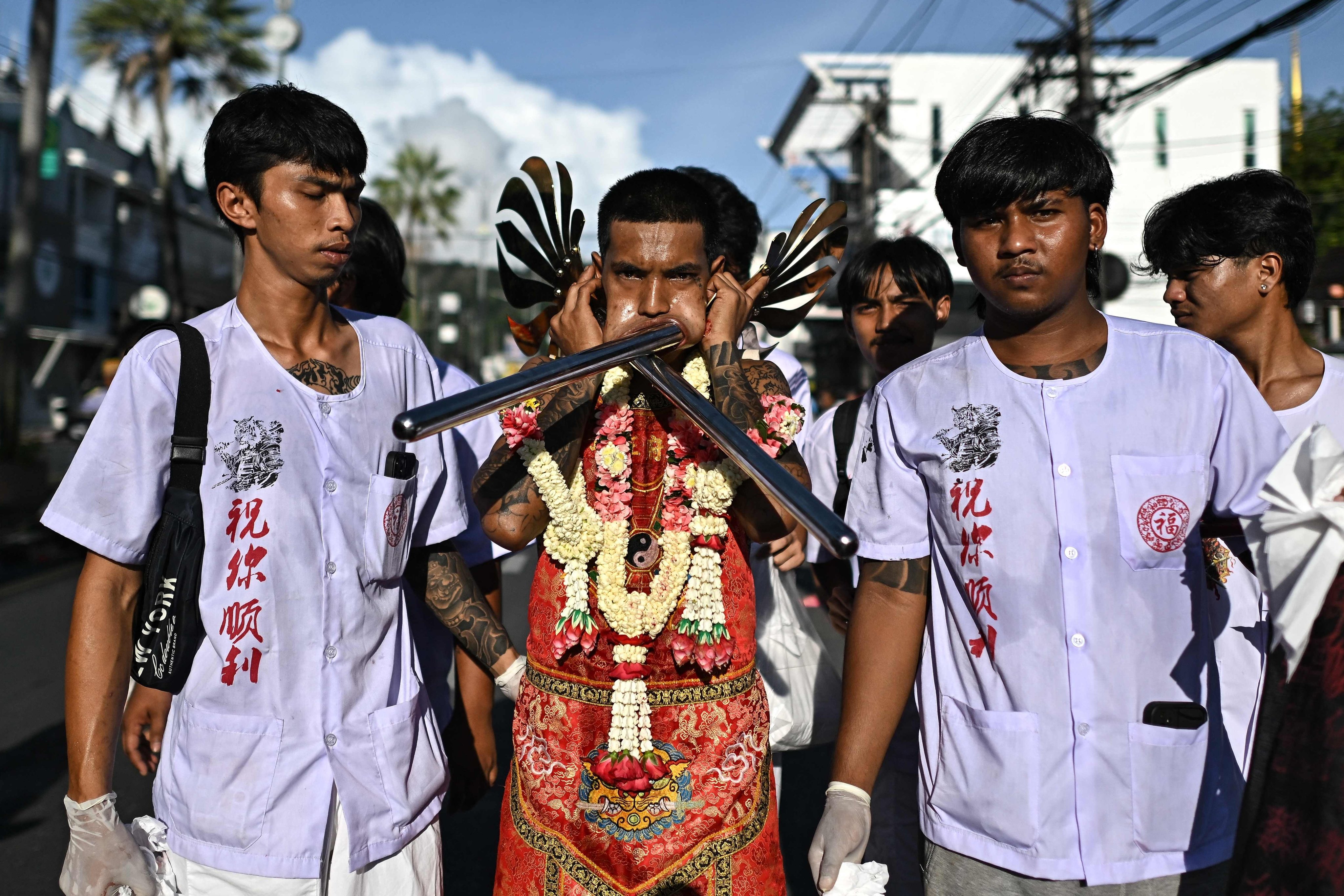 A devotee with skewers pierced through his cheek. Photo: AFP