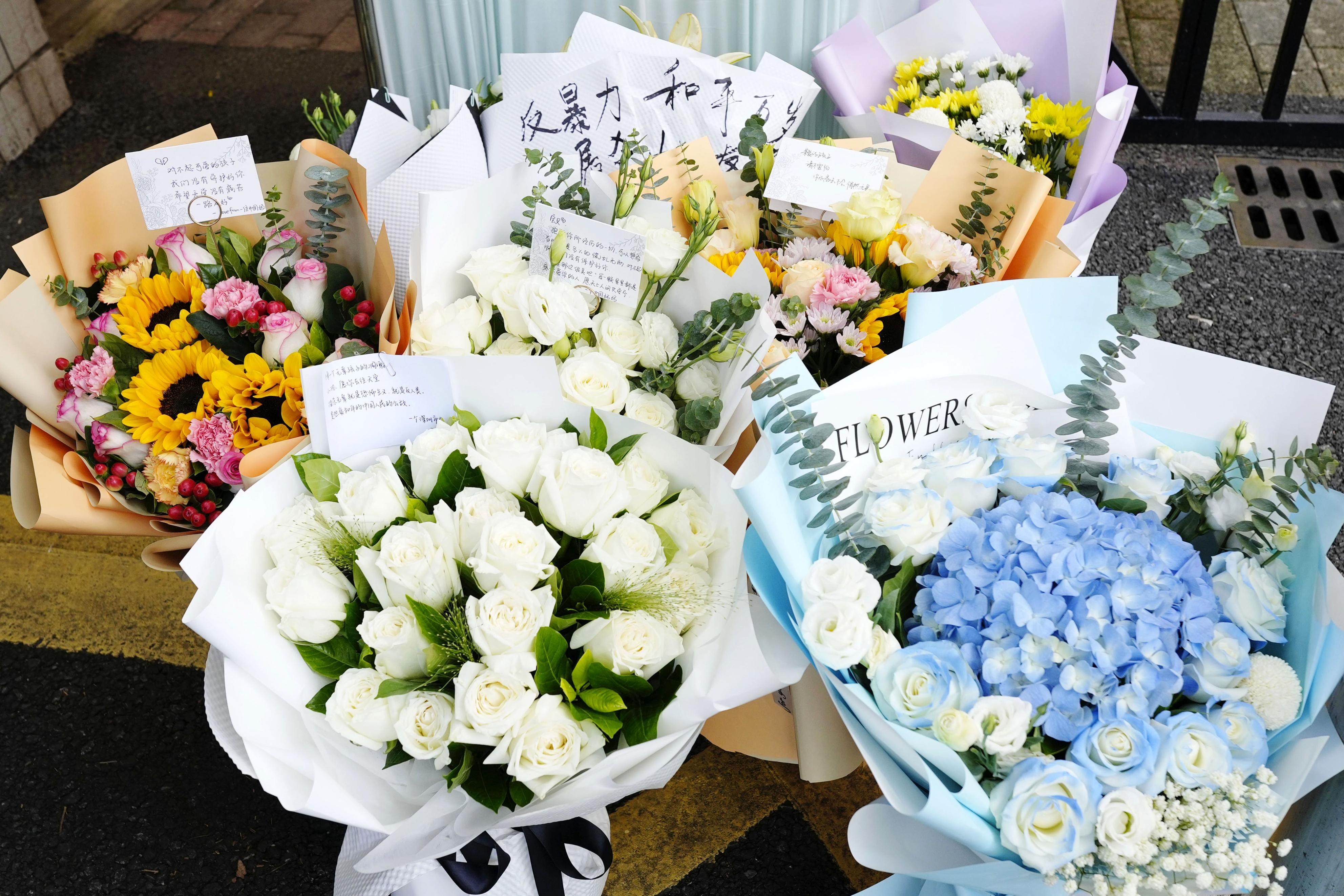 Flowers are seen in front of Shenzhen Japanese School following the death of a 10-year-old boy who was fatally stabbed on his way to the school last month. Photo: Kyodo